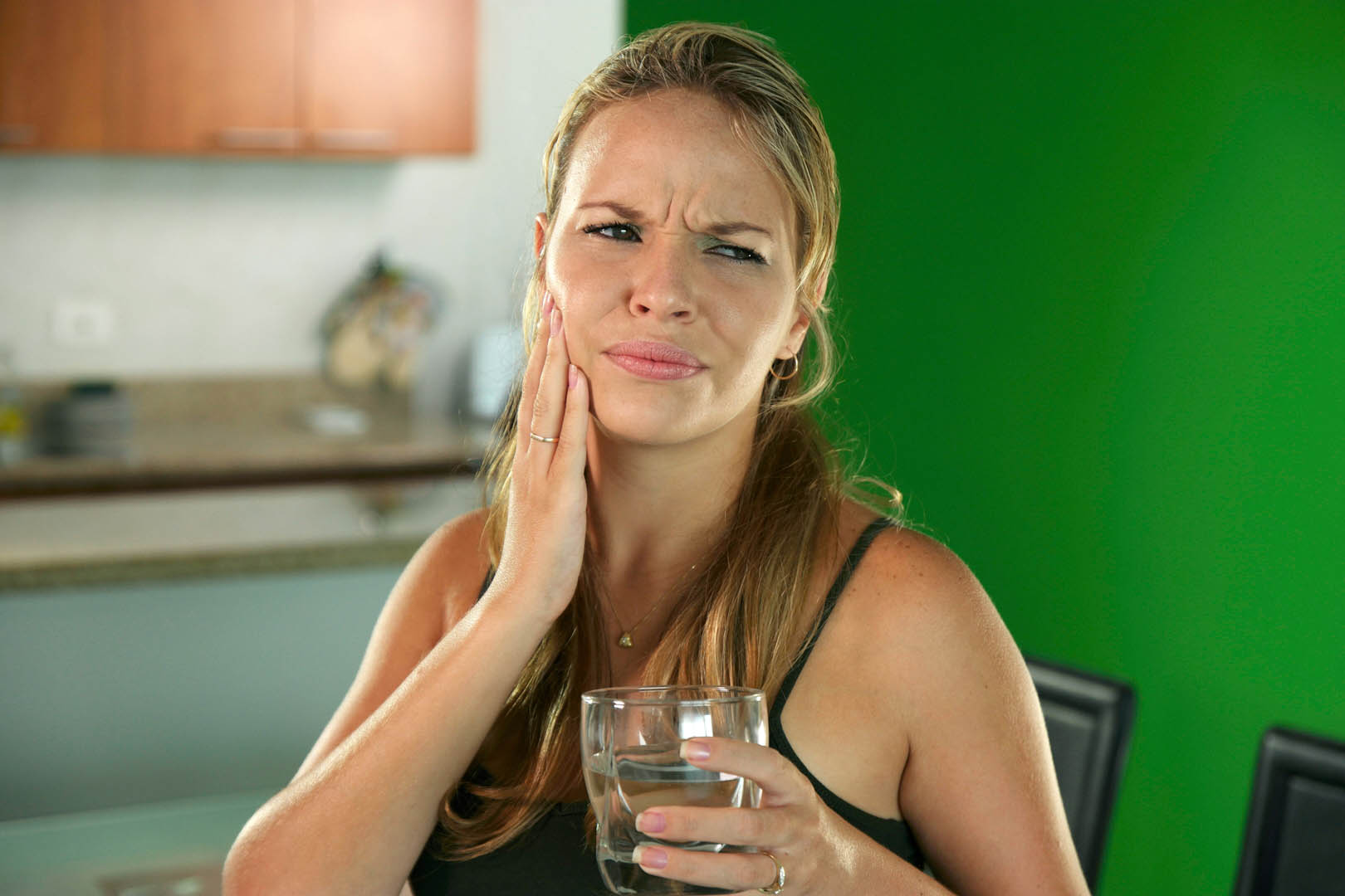 woman who needs to see a periodontist in Pompano Beach for her sensitive teeth