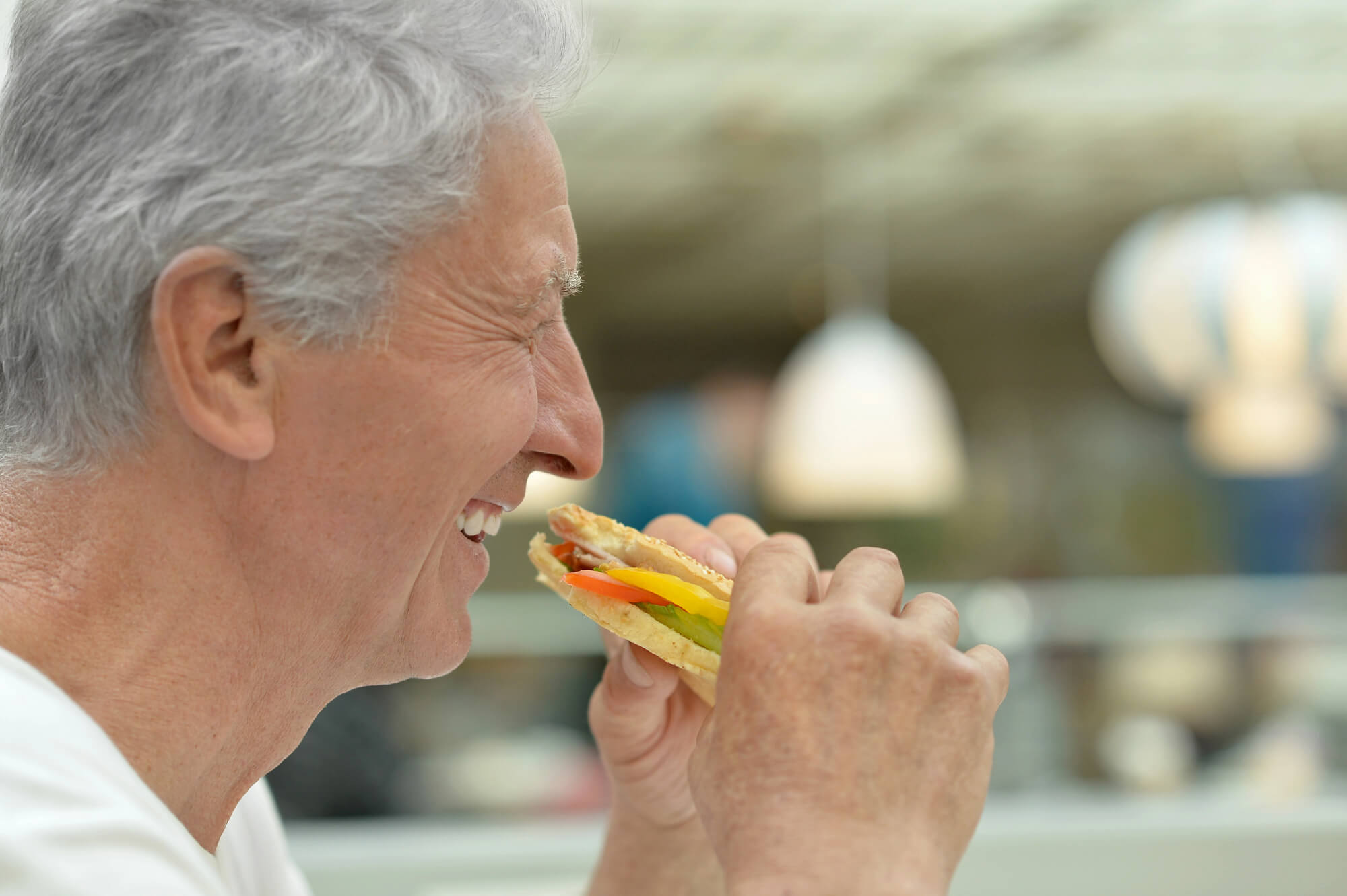 Man Eating After Getting an Implant with an Oral Surgeon in Pompano Beach