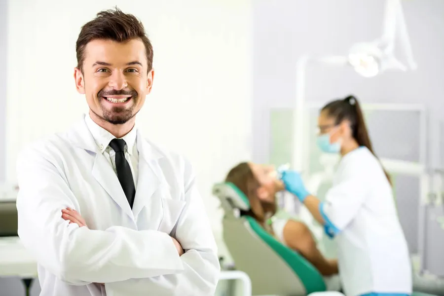 dentist-in-Pompano-Beach-smiling-dentist-in-office
