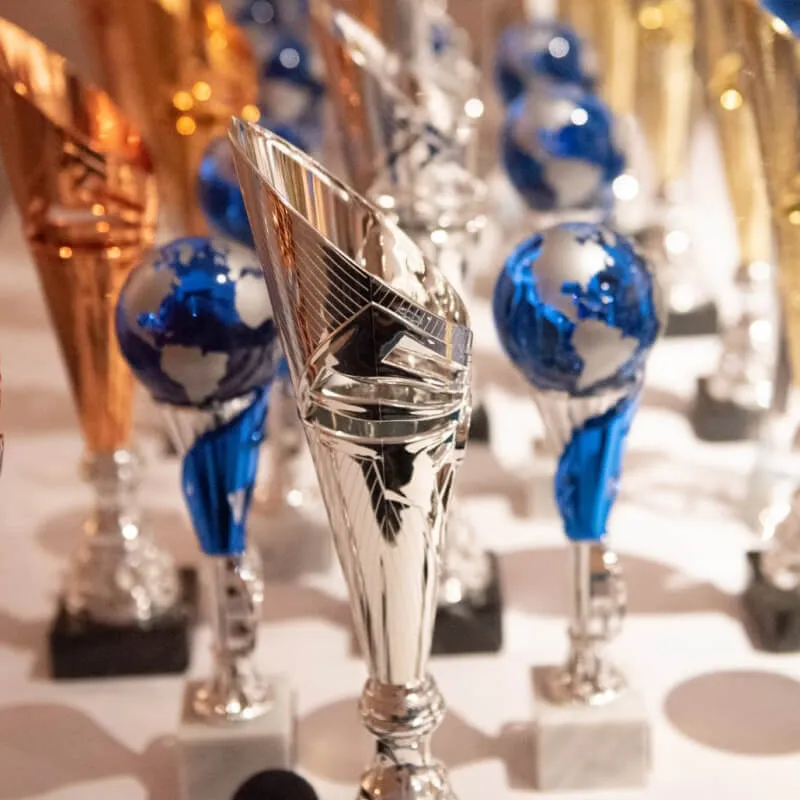 Close up of some blue and golden trophies