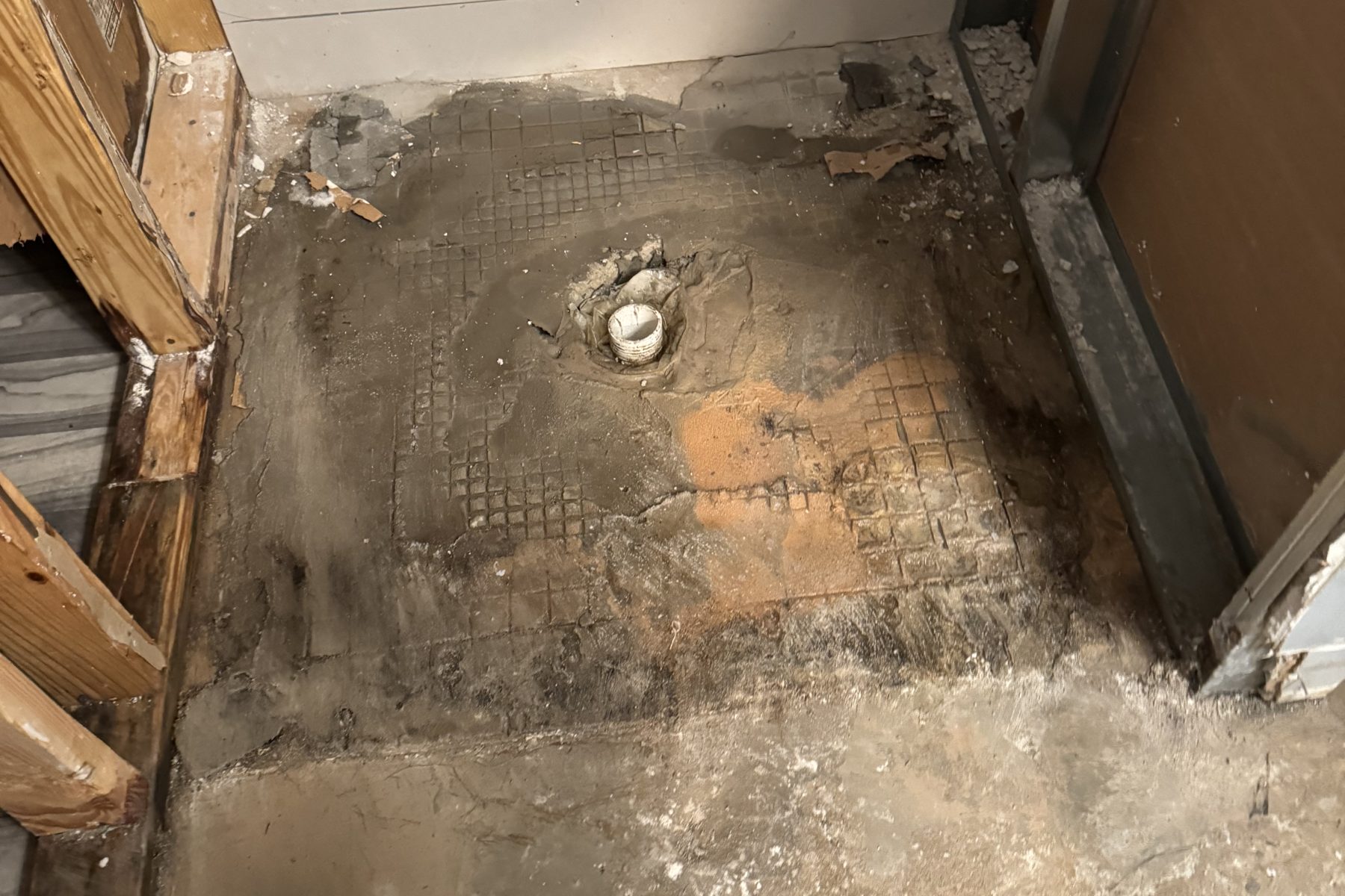 Bathroom stripped to a water-damaged subfloor