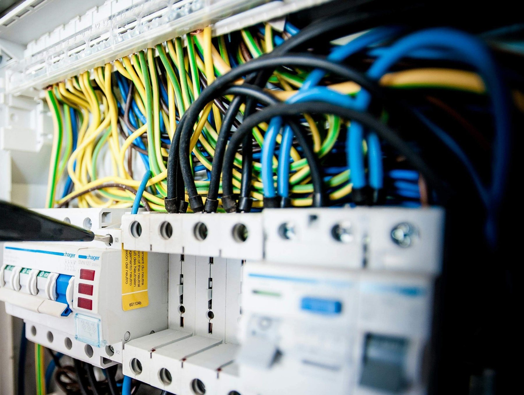 Exposed wiring and circuit breakers in an electrical panel