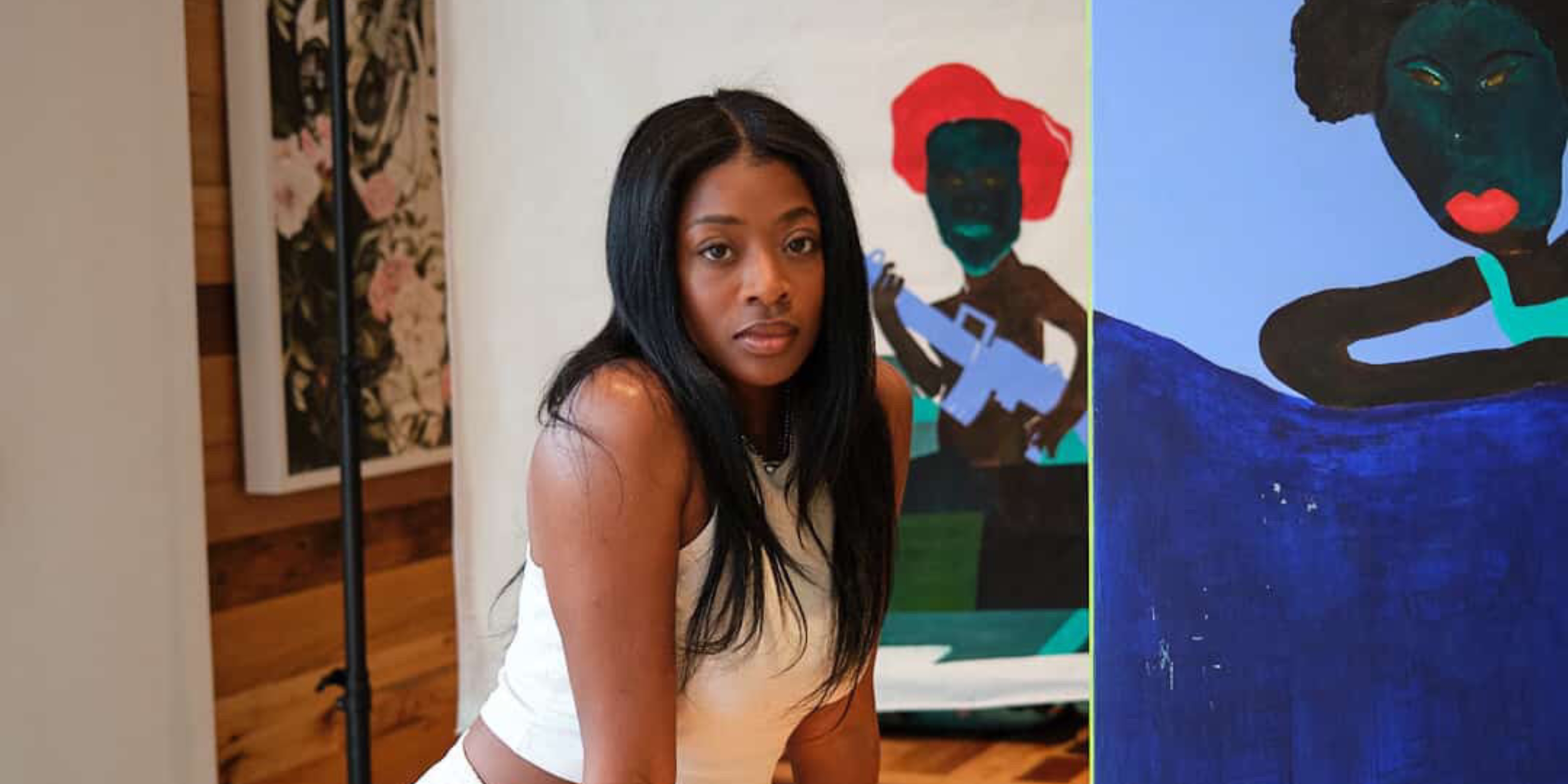 Artist Dandora Sillah pictred with her artwork