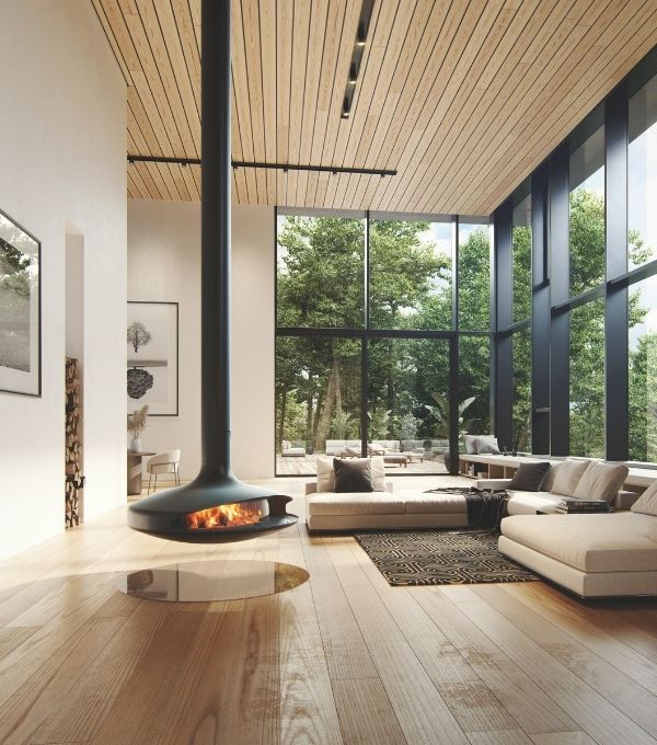 Suspended gyrofocus woodburner in a large lounge with ceiling high windows 