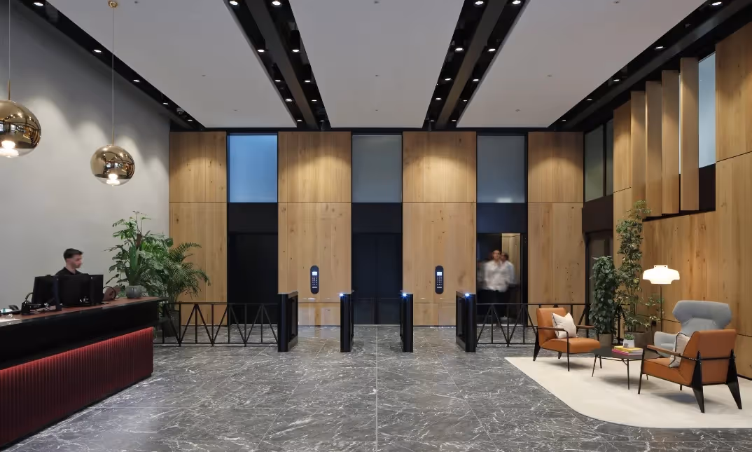 Building front reception area with shared workspace and kitchen facilities.