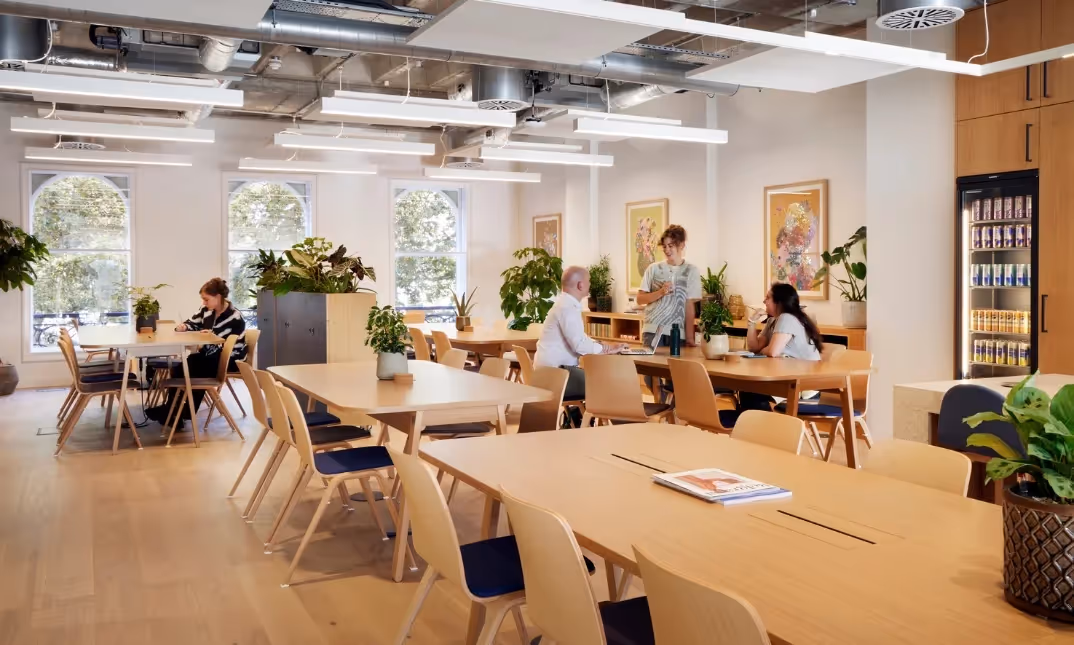 Second floor shared coworking area with kitchen facilities.