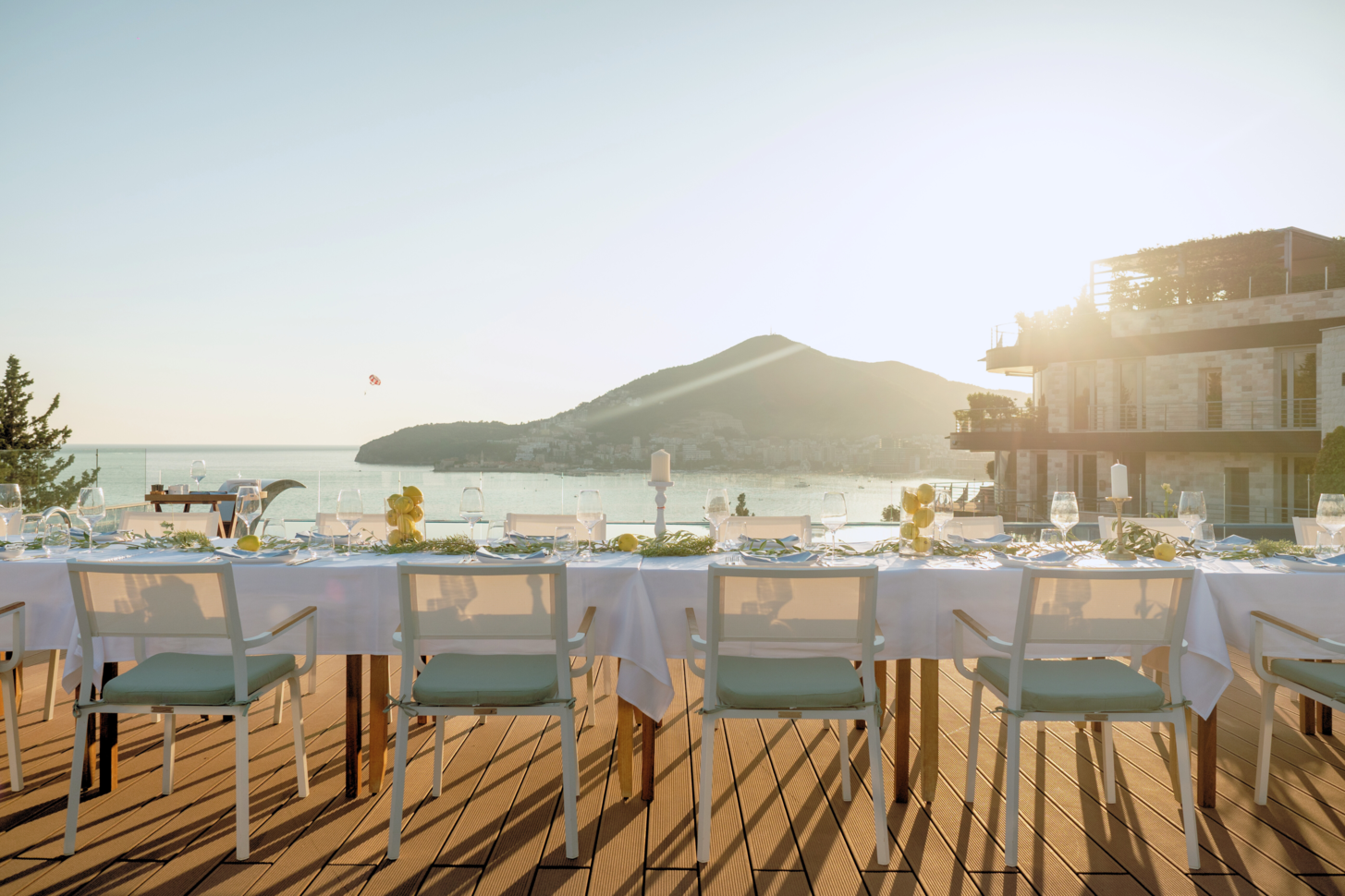 Infinity Pool Club wedding venue at night with a view of Bečići city lights reflecting onto the Adriatic sea. 