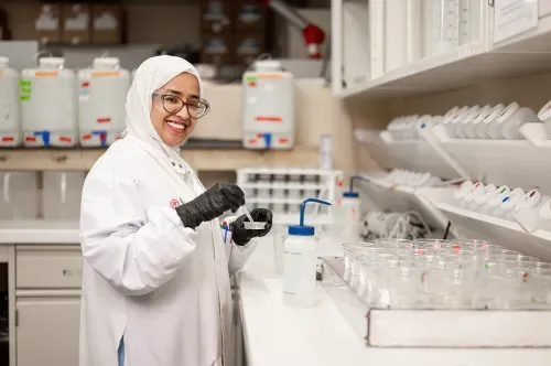 Female scientist preparing mixture in laboratory