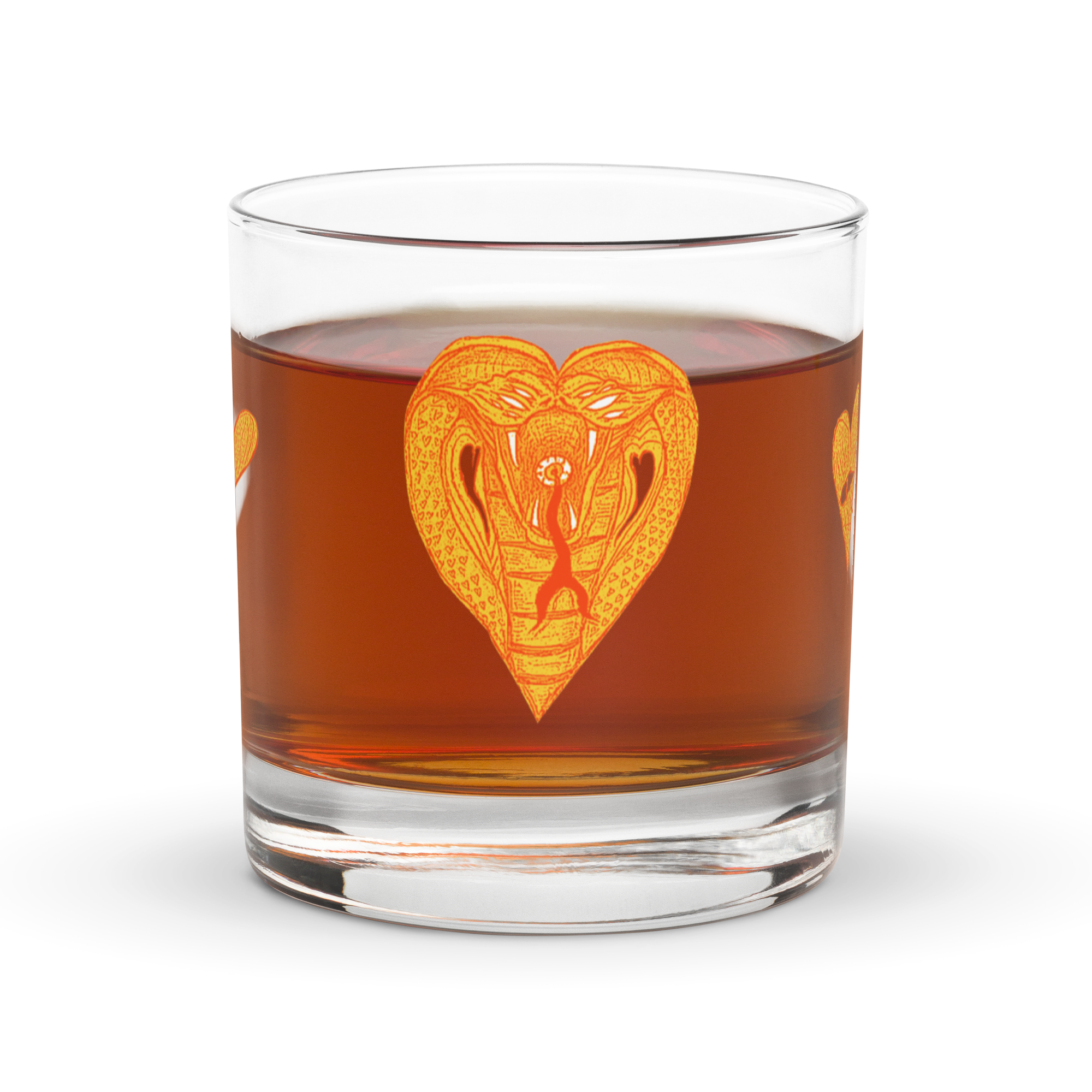 A whiskey rocks glass with a heart-shaped cobra on it.