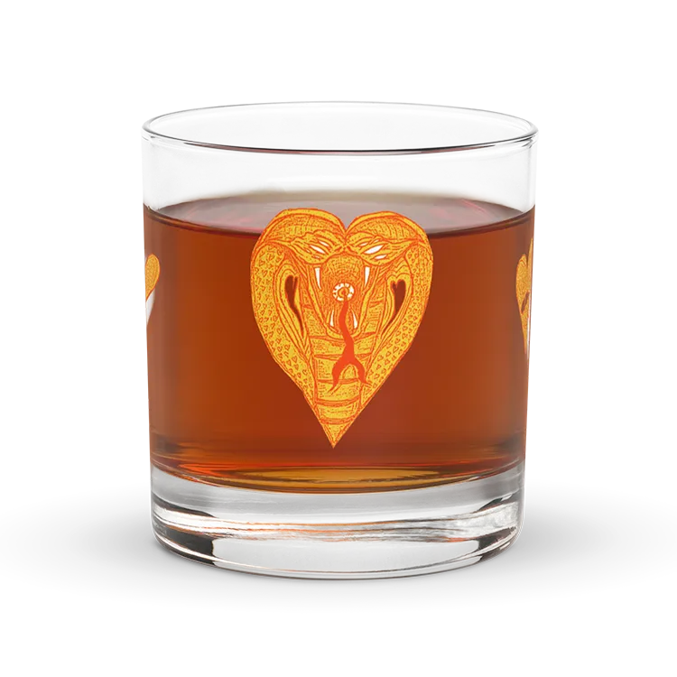 A Rocks glass with a snake and hearts on it.