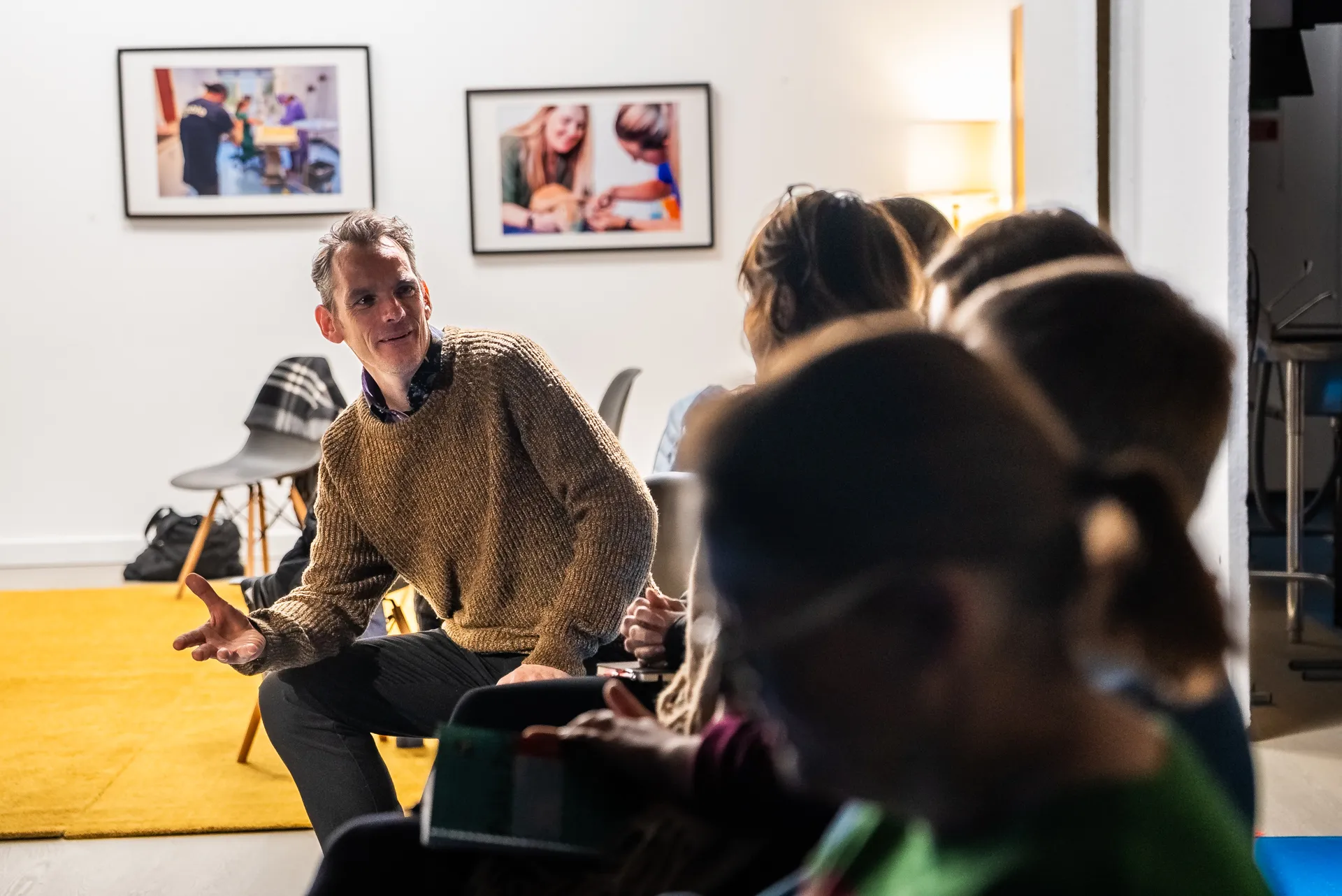 A group of people sitting in chairs in a room.