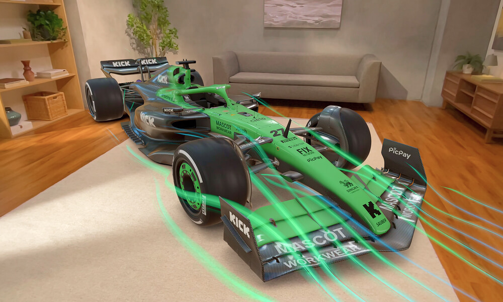 Green and black Formula 1 race car with aerodynamic flow lines displayed on a carpet in a modern living room.