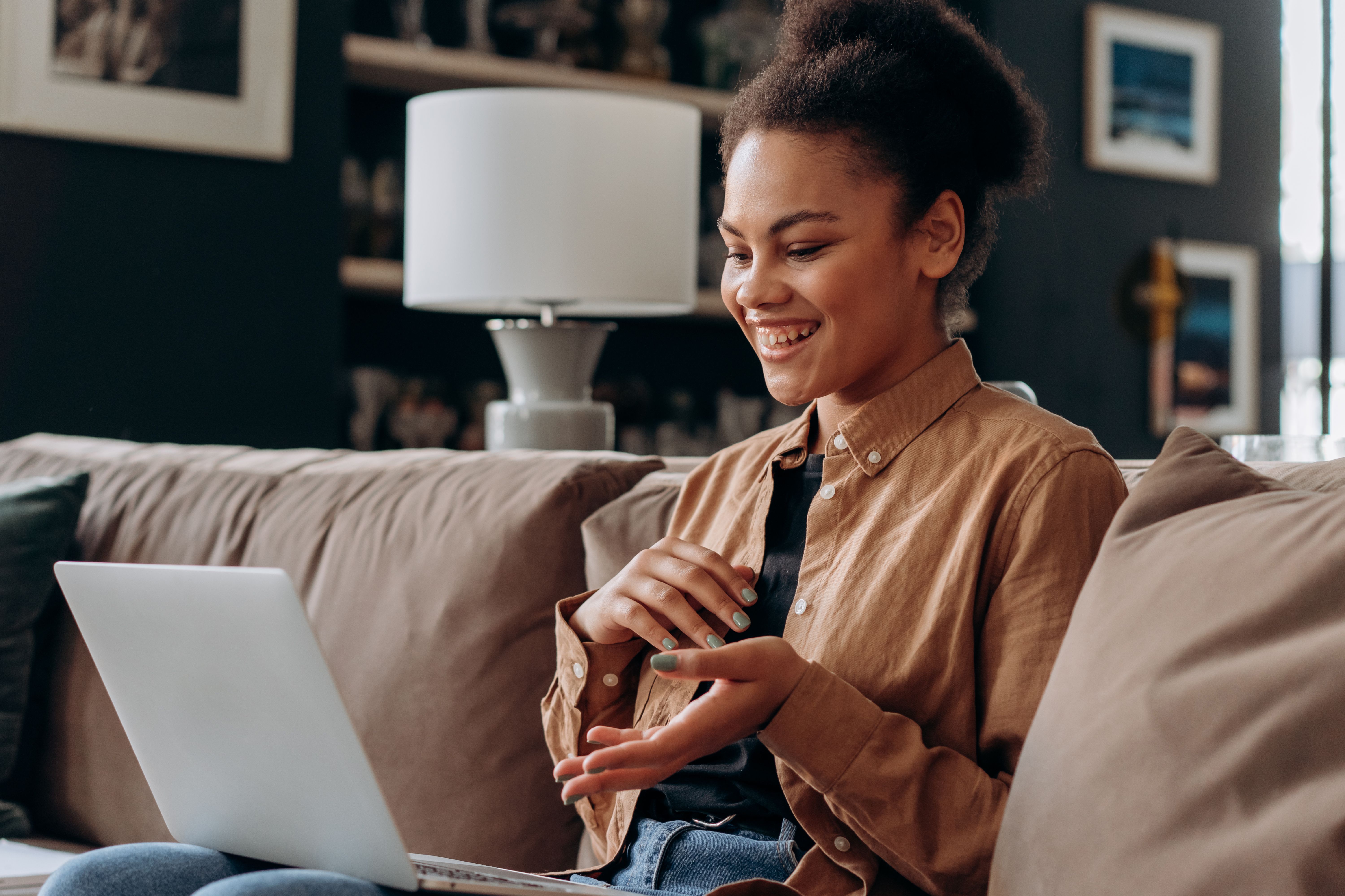 Young woman on laptop while sitting on a couch