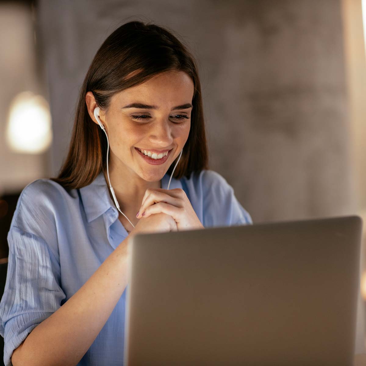 Young woman on laptop with headphones