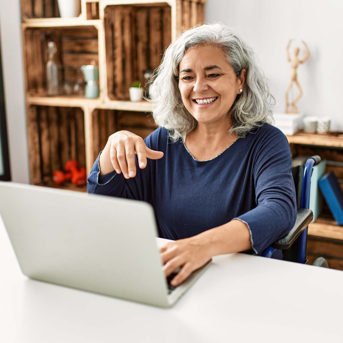Elderly woman on laptop at desk