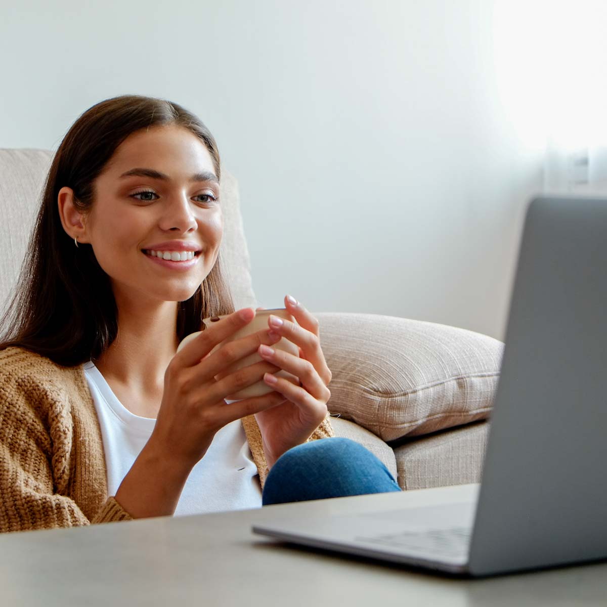 Young woman on laptop in living room