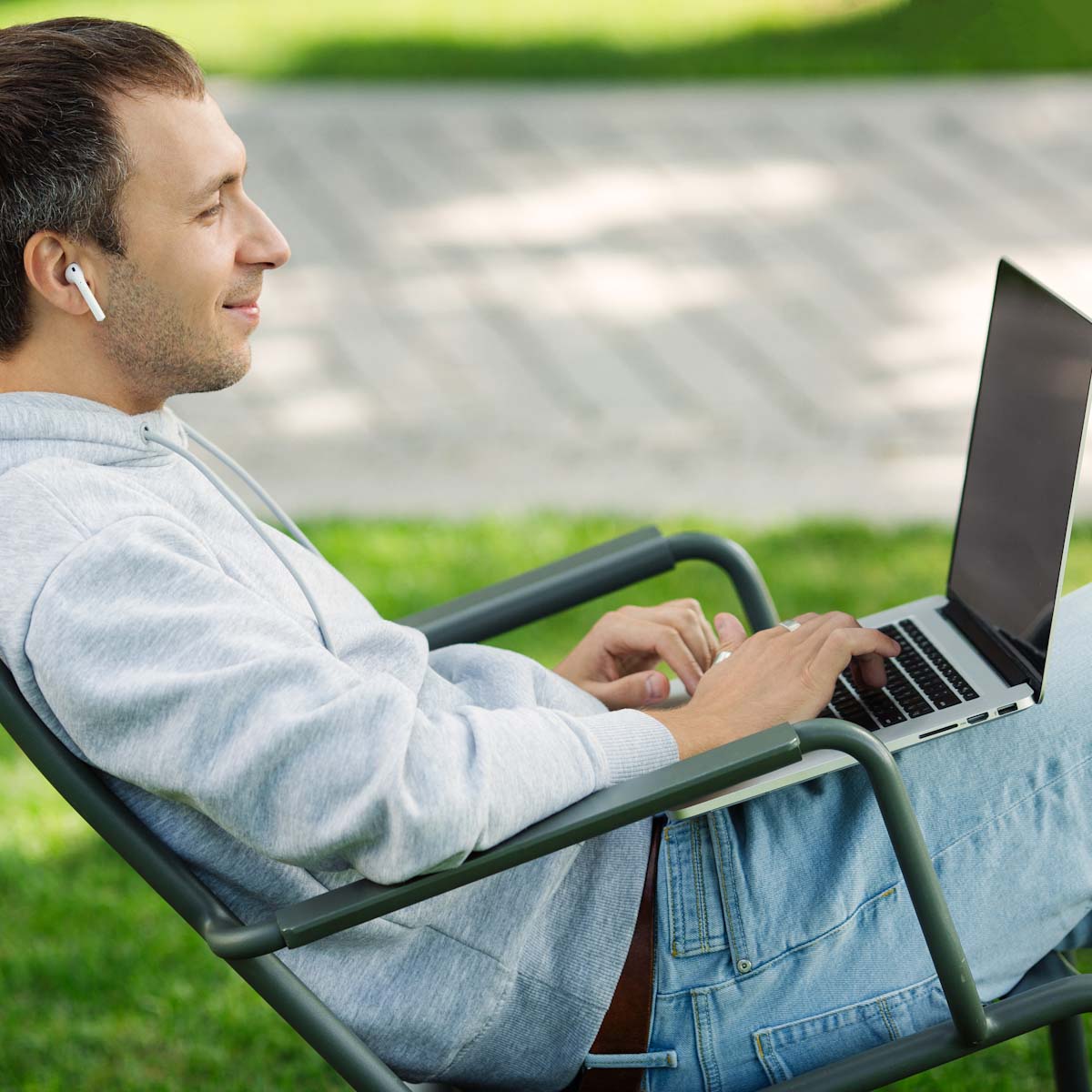 Middle age man on laptop outside