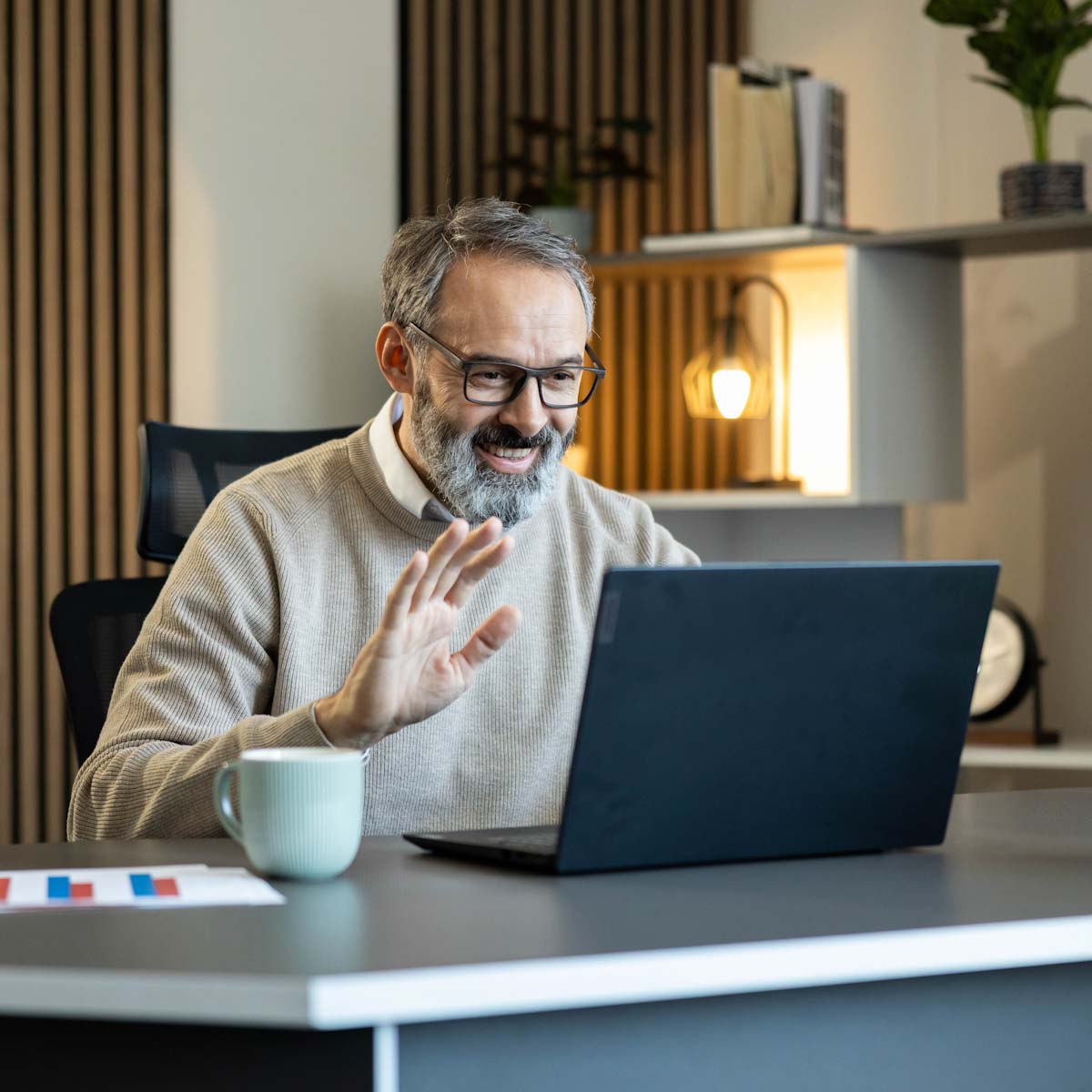Middle age man on laptop at counter