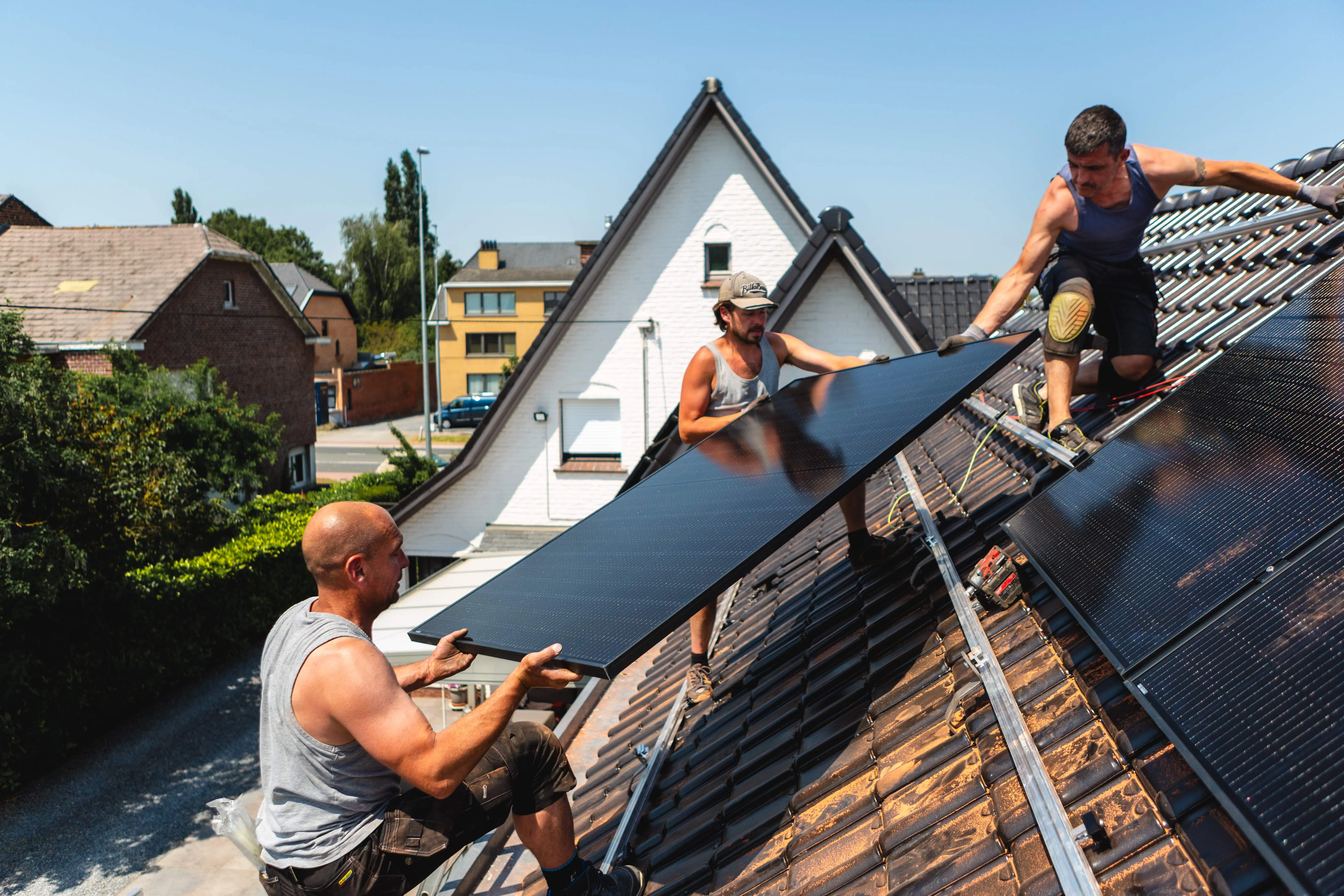 A couple of men working on a roof.