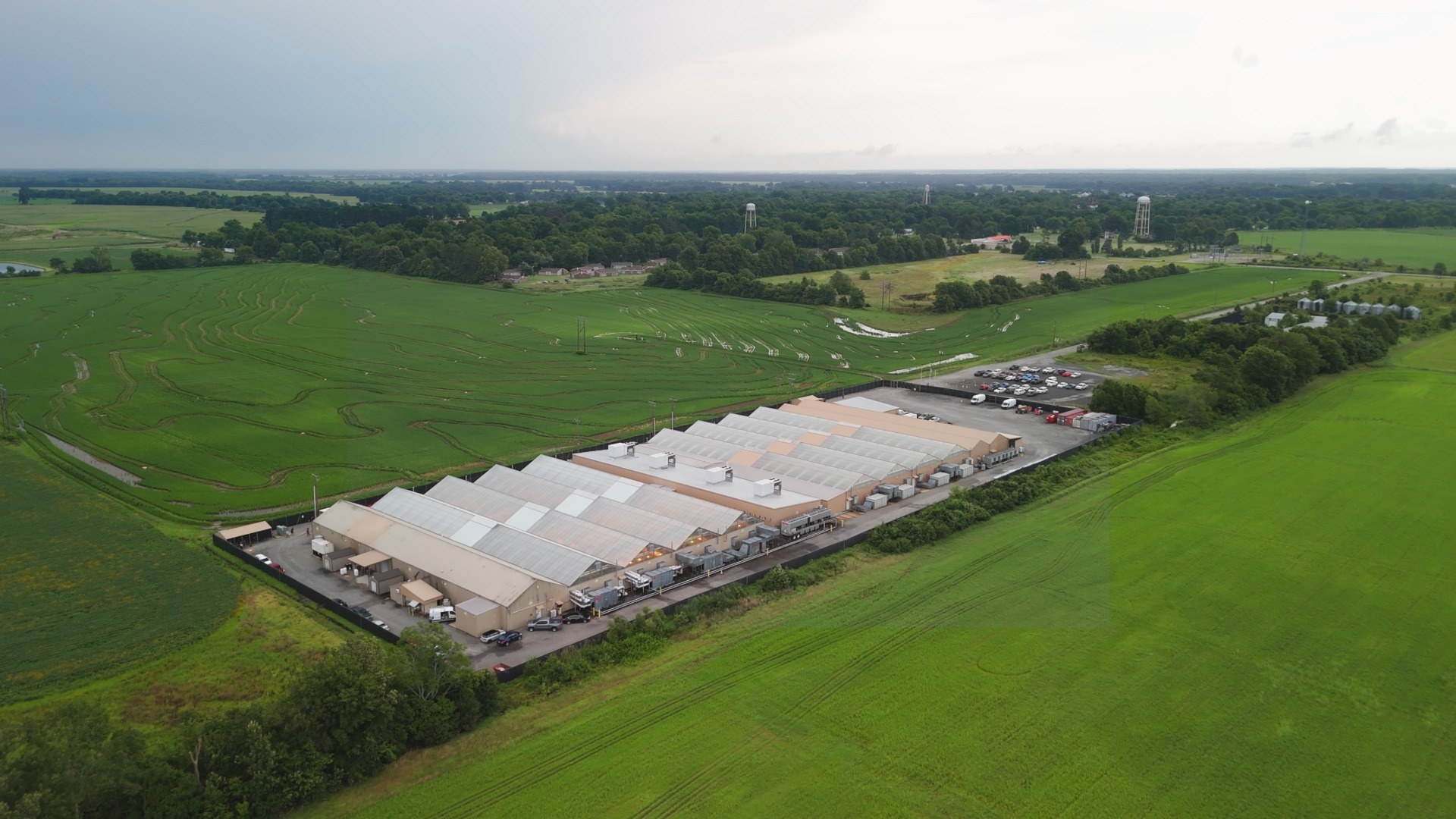 Aerial view of BOLD Cannabis cultivation facility in Cotton Plant Arkansas showing large commercial greenhouse operation surrounded by agricultural farmland.