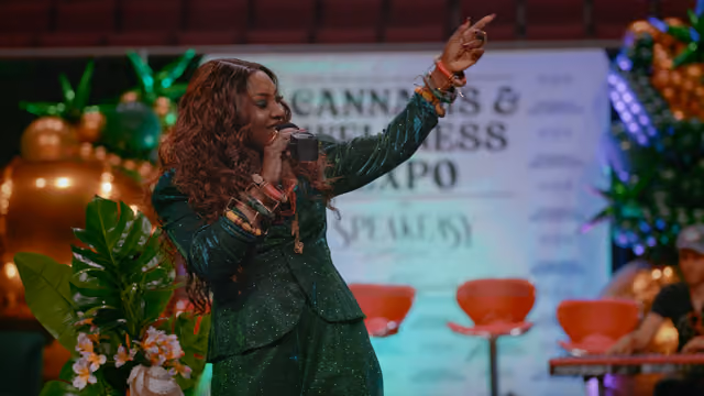 Rochelle Bradshaw performing at Cannabis & Wellness Expo stage, composer of the original score for Roots & Reefer documentary.