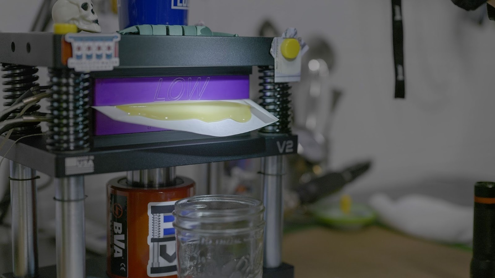 Live rosin being pressed on extraction equipment at RVR, showing golden cannabis concentrate emerging from rosin press.