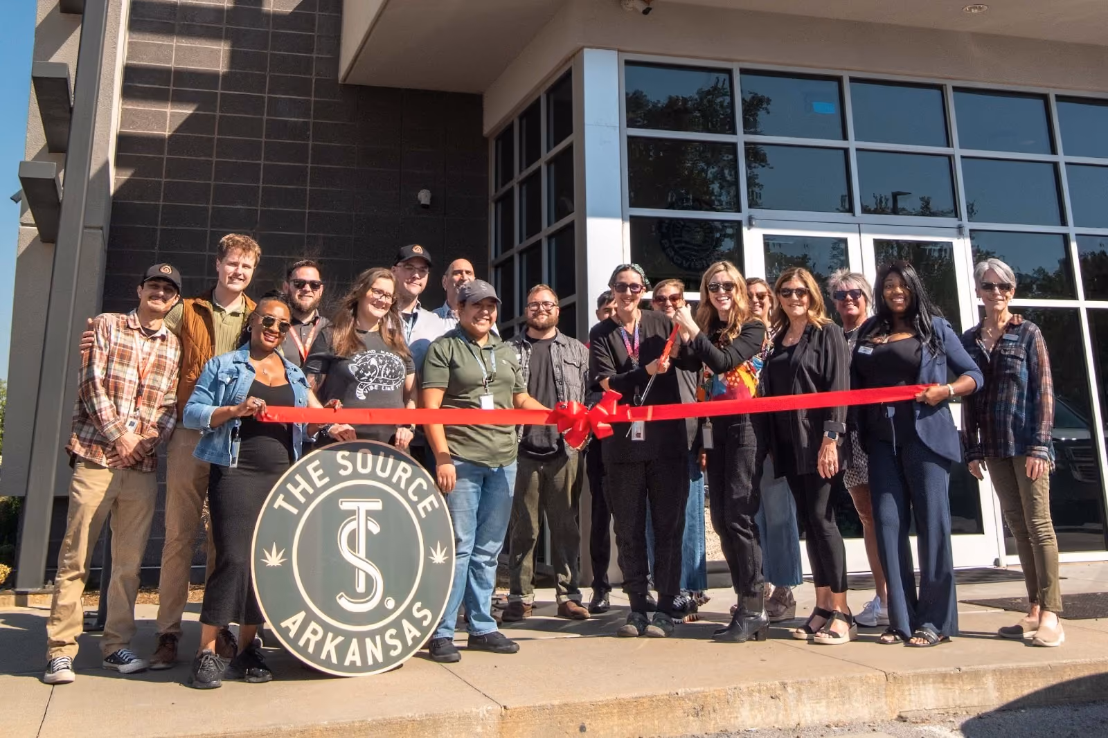 The Source team and Rogers Lowell Chamber of Commerce members at ribbon cutting ceremony outside Rogers, Arkansas dispensary.