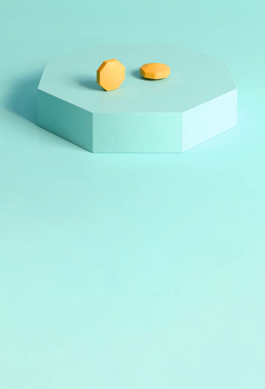 ミントグリーン色の台の上にある2錠のフィナステリド1mg