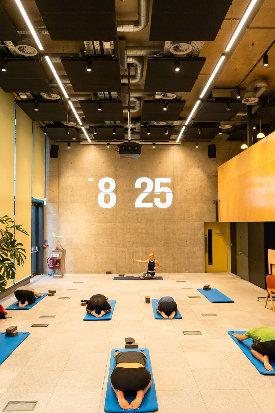 Members practising Yoga in the Launch Space at Plus X Innovation Brighton.