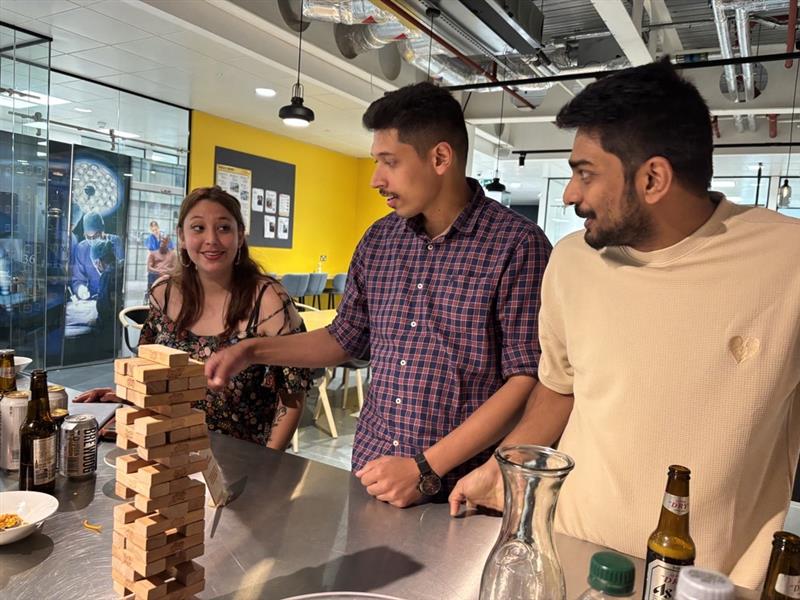 Plus X innovation Members playing a game of Jenga at the Weekly Social . 