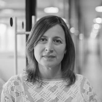 black and white photo of a woman with mid length hair lightly smiling
