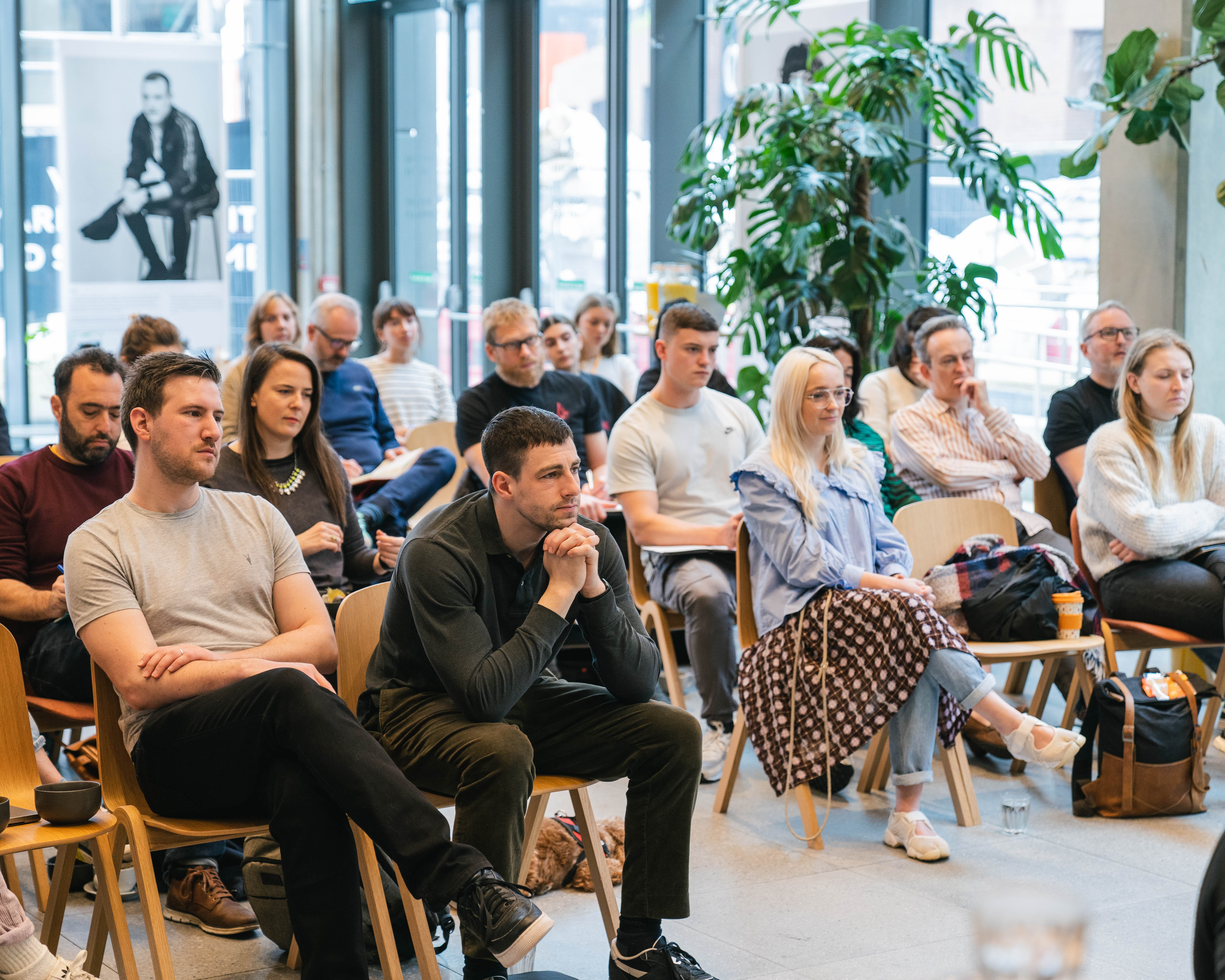 A group of people listening to a presentation