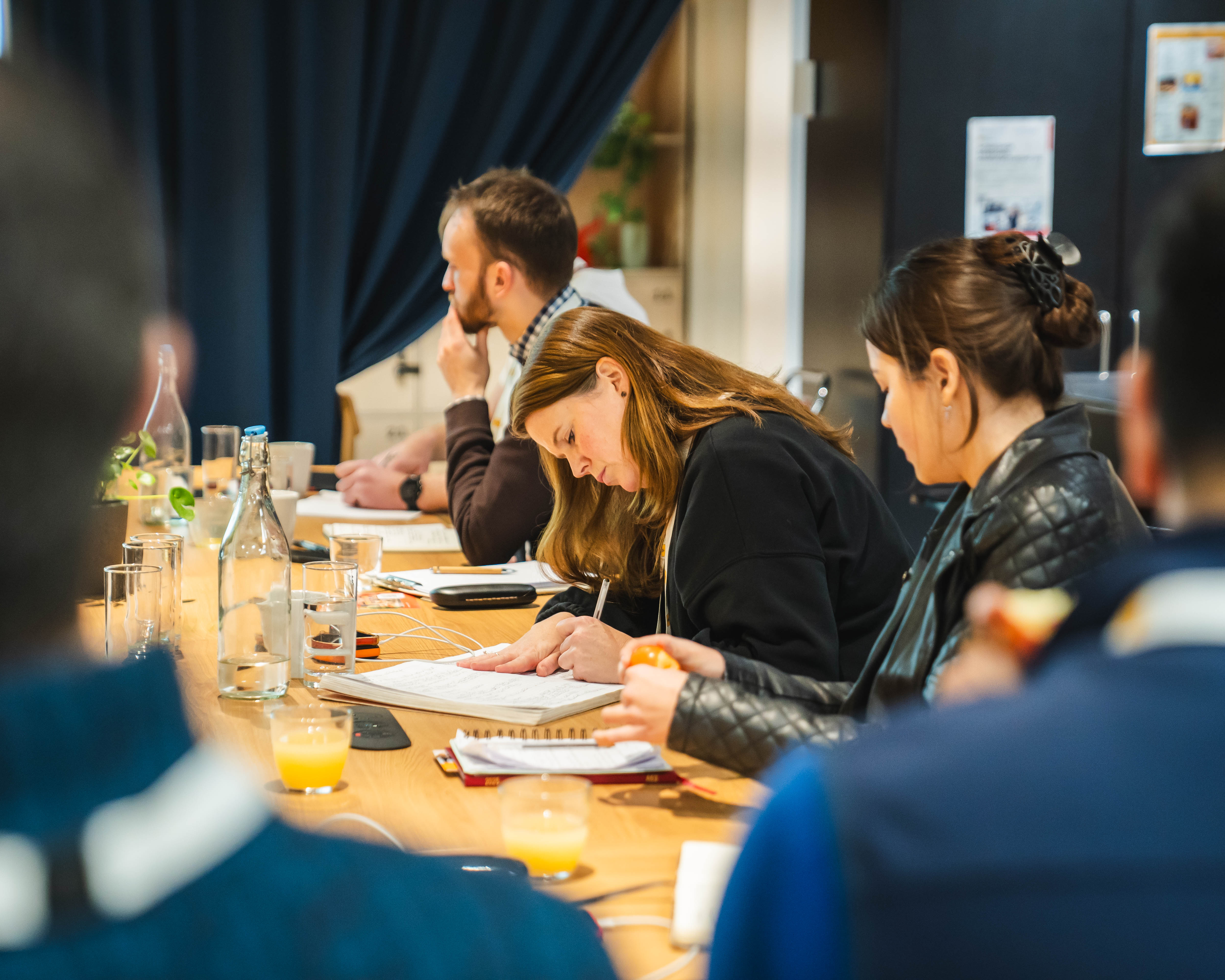 Delegates taking notes at a programme