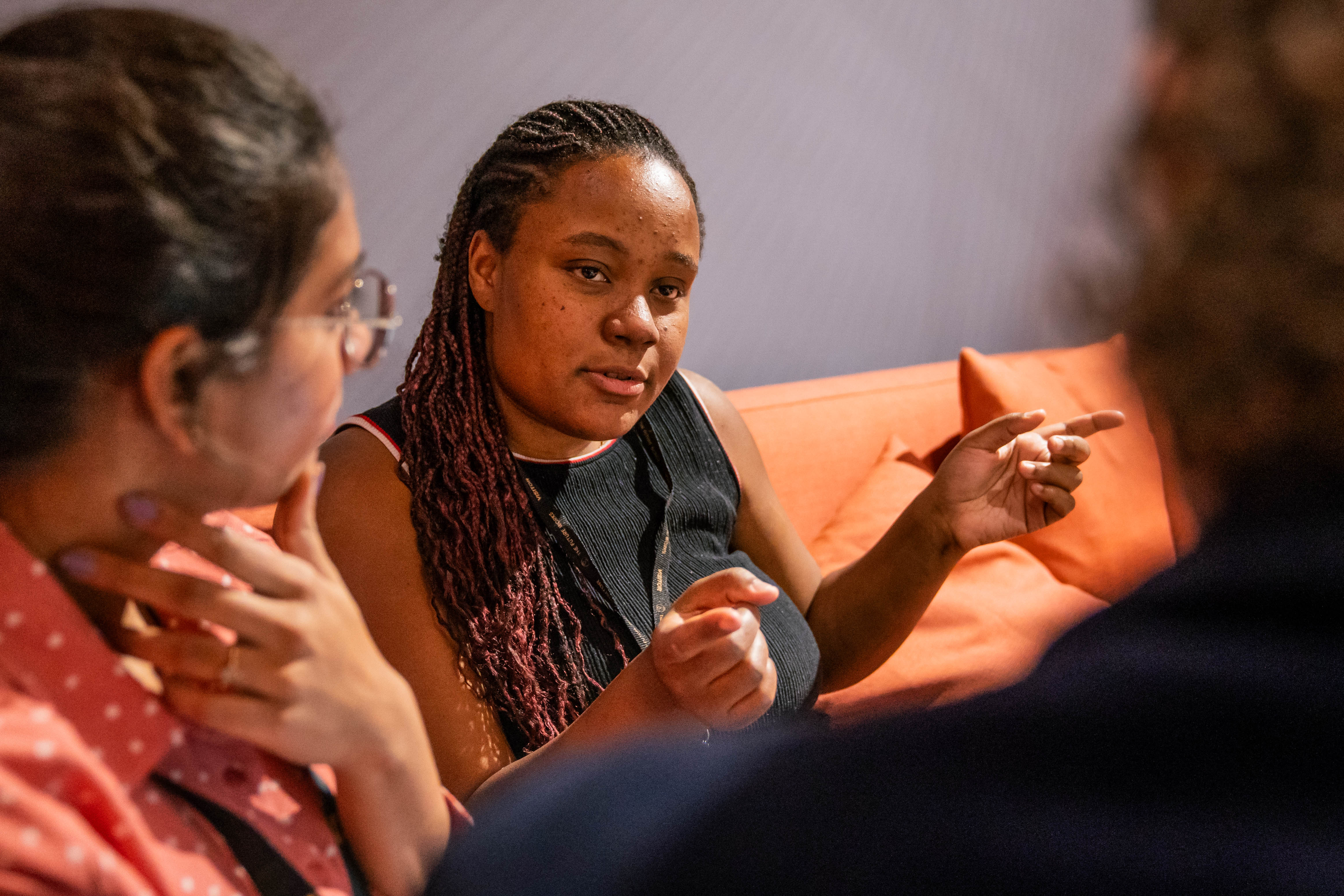 A woman talking to her colleagues .