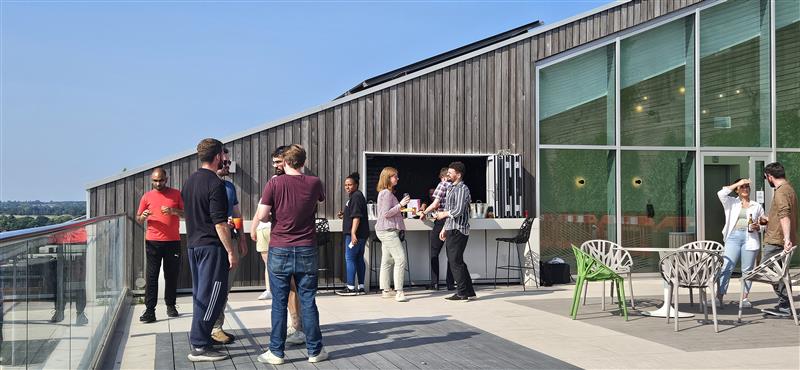Plus X Innovation Slough members socialising on the 8th floor rooftop