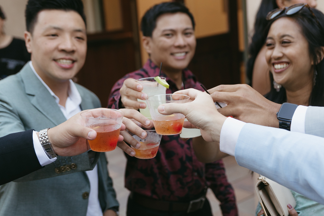 Guests cheers with cocktail hour signature drinks.