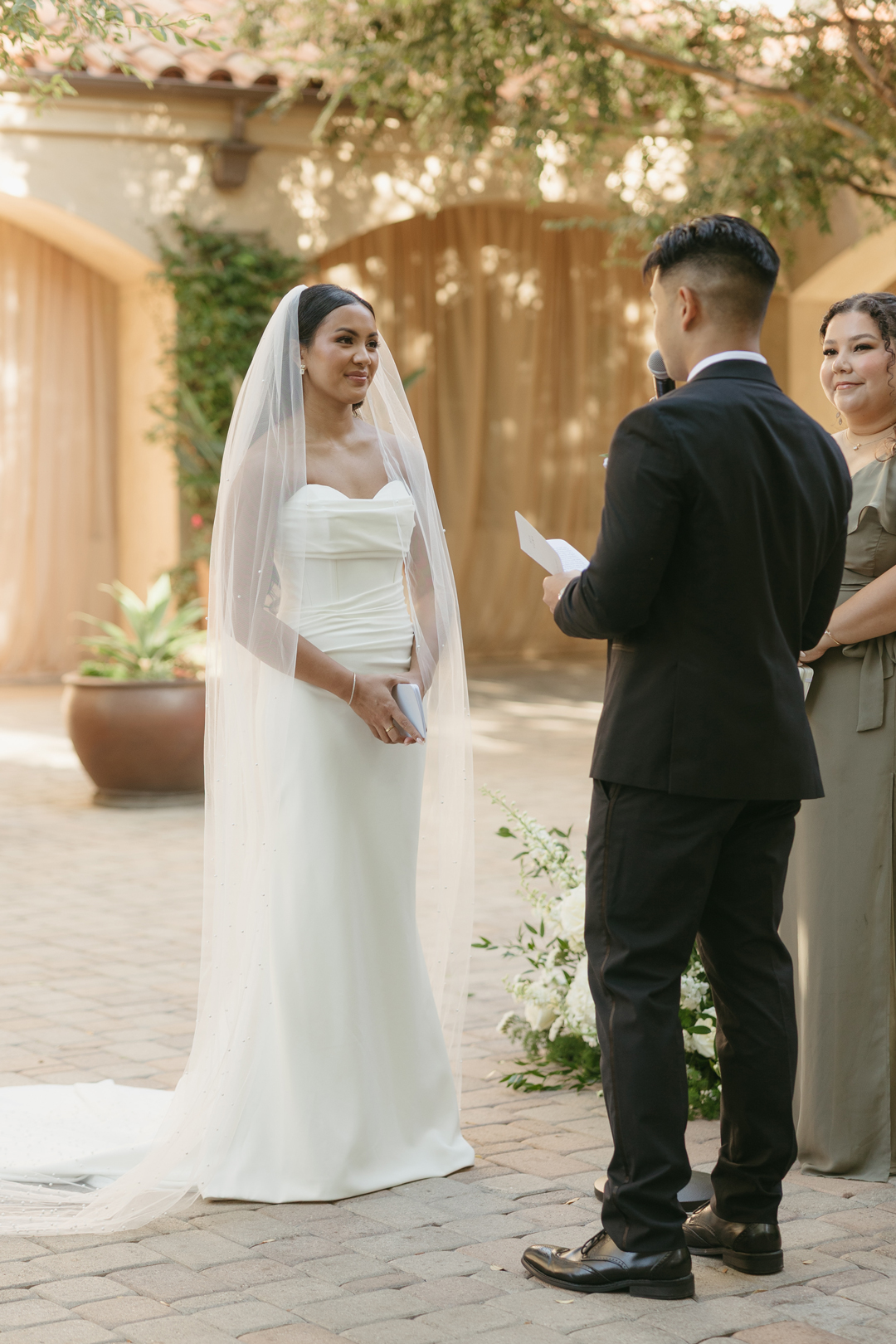 Groom reads vows to bride.