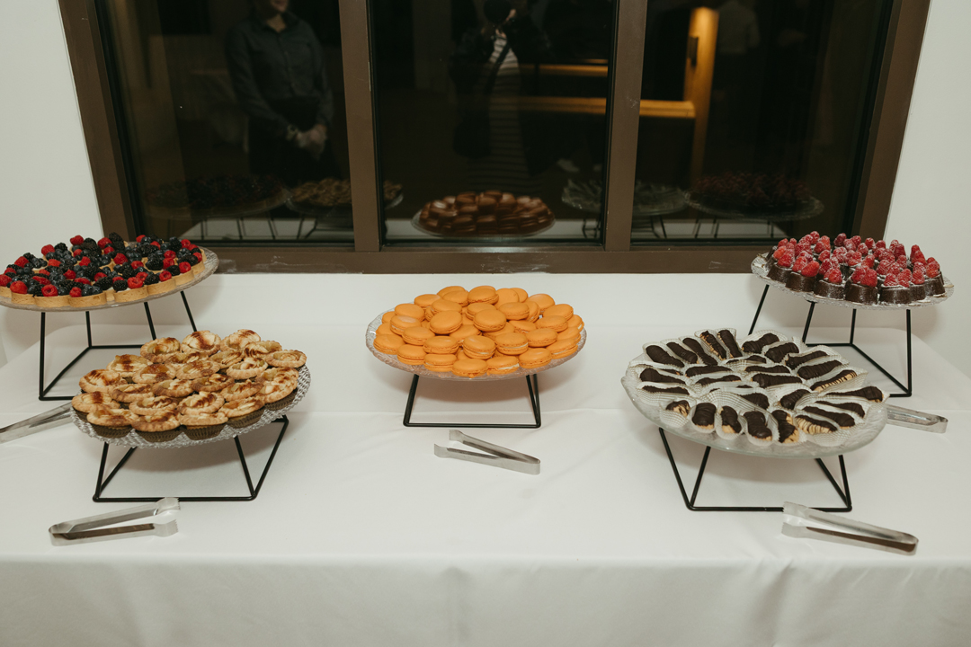 Bite-sized wedding desserts sit arranged on a table for guests to enjoy after dinner.