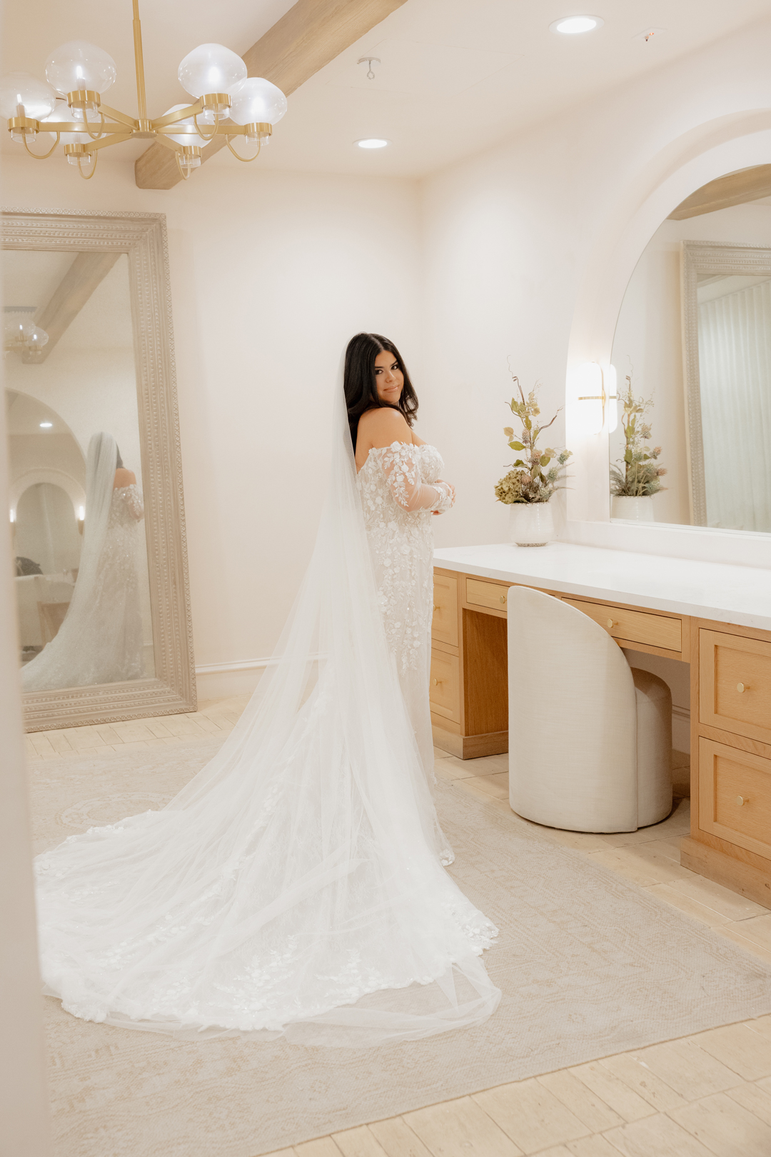 Bride smiling at the camera inside the Serra Plaza Spanish Revival style Bridal Suite after getting ready.