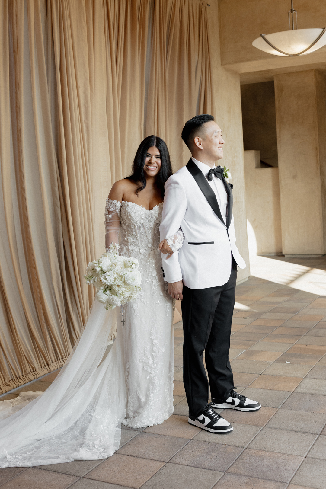 Bride and groom pose for wedding portraits.