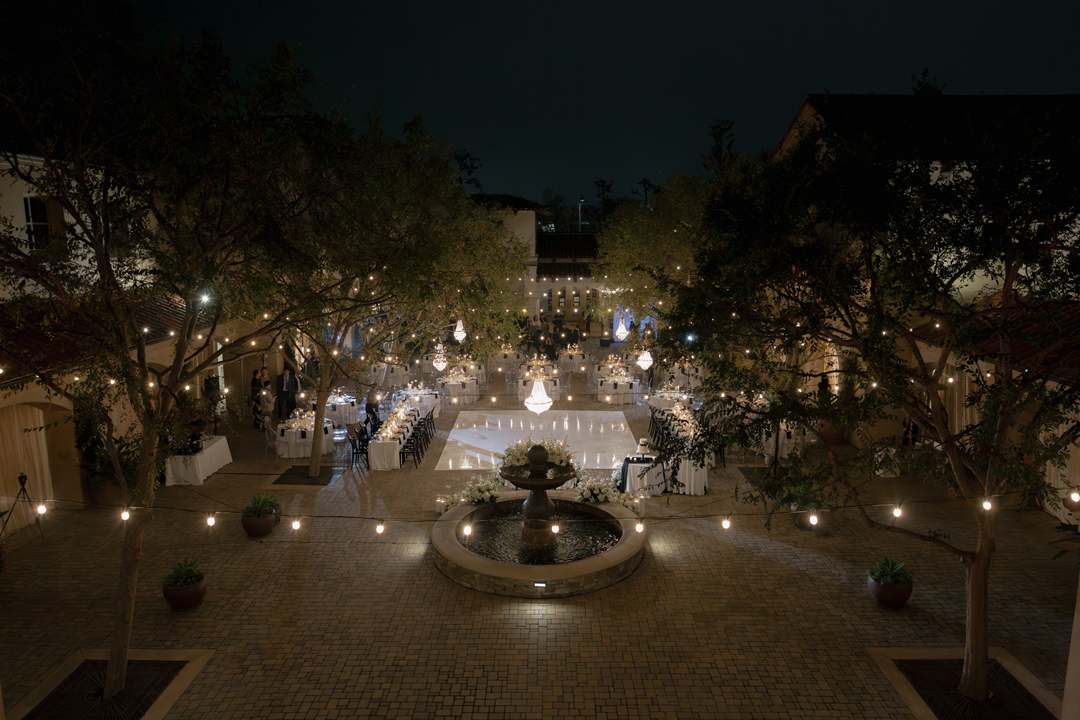 Romantic, candlelit outdoor wedding reception with black and white details.