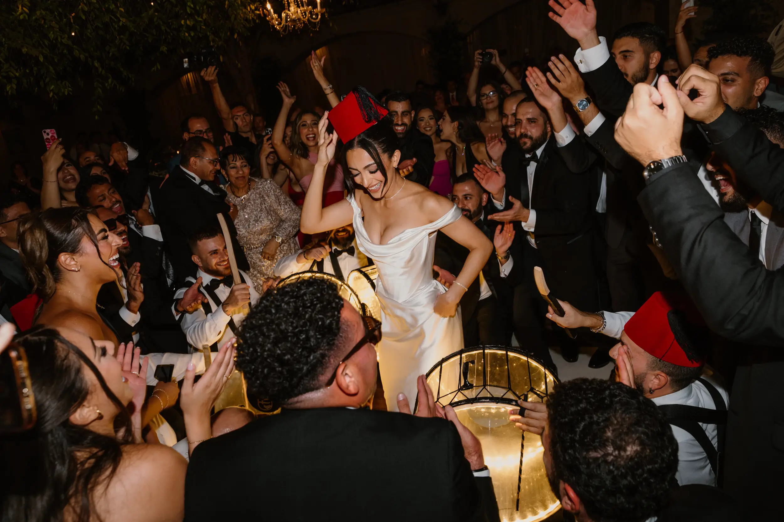 Bride and groom dance with guests for their wedding reception grand entrance.