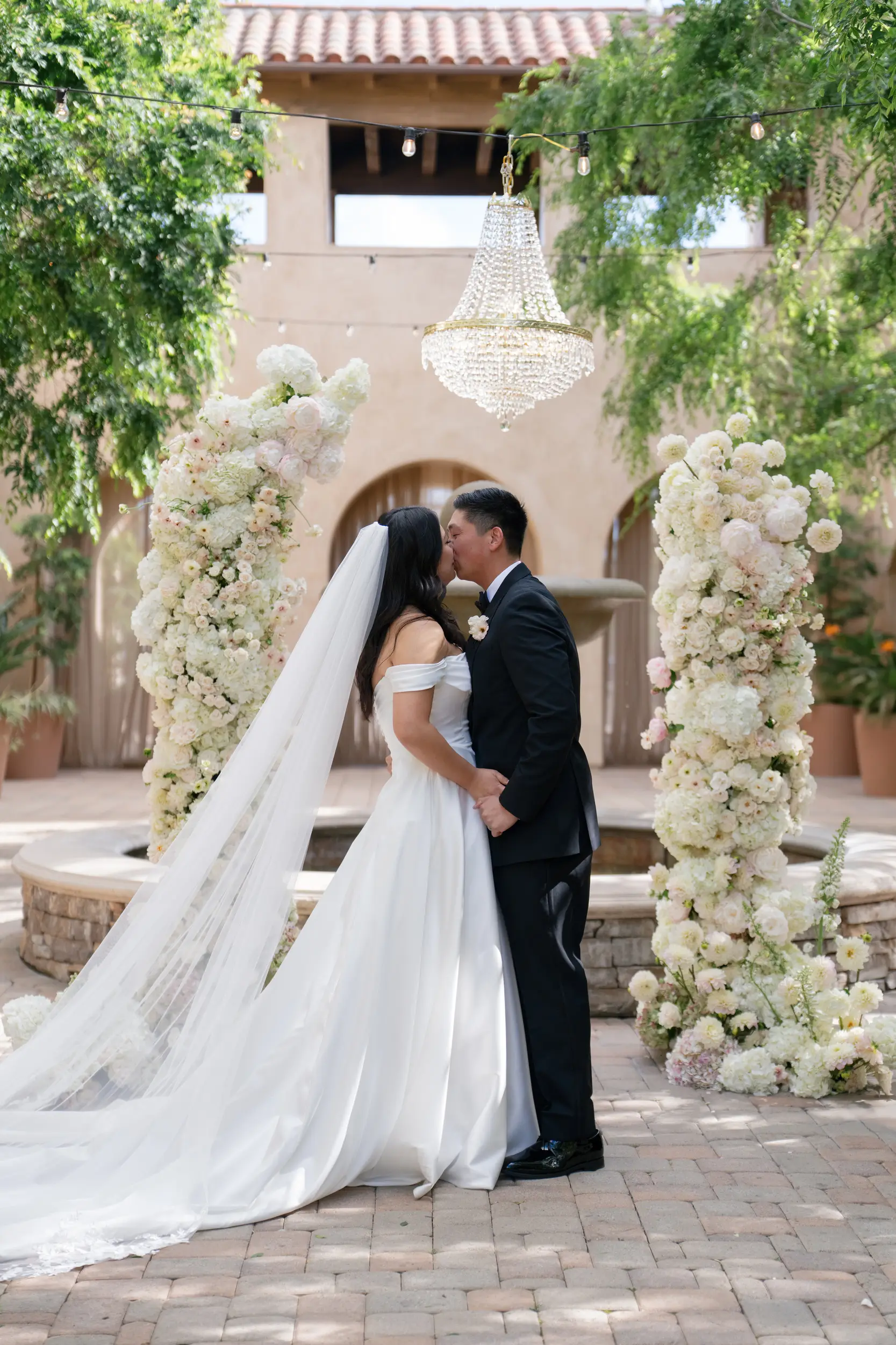 Bride and groom share ceremony kiss.