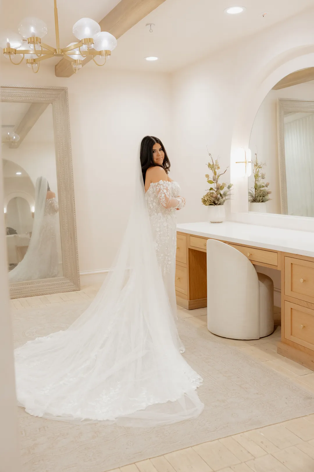 Bride smiling at the camera inside the Serra Plaza Spanish Revival style Bridal Suite after getting ready.