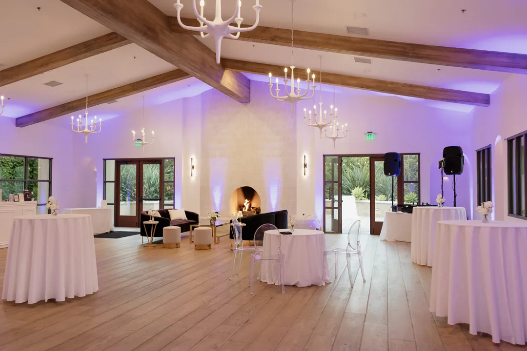 Purple uplighting lights up Serra Plaza's Spainsh Revival wedding venue for cocktail hour.