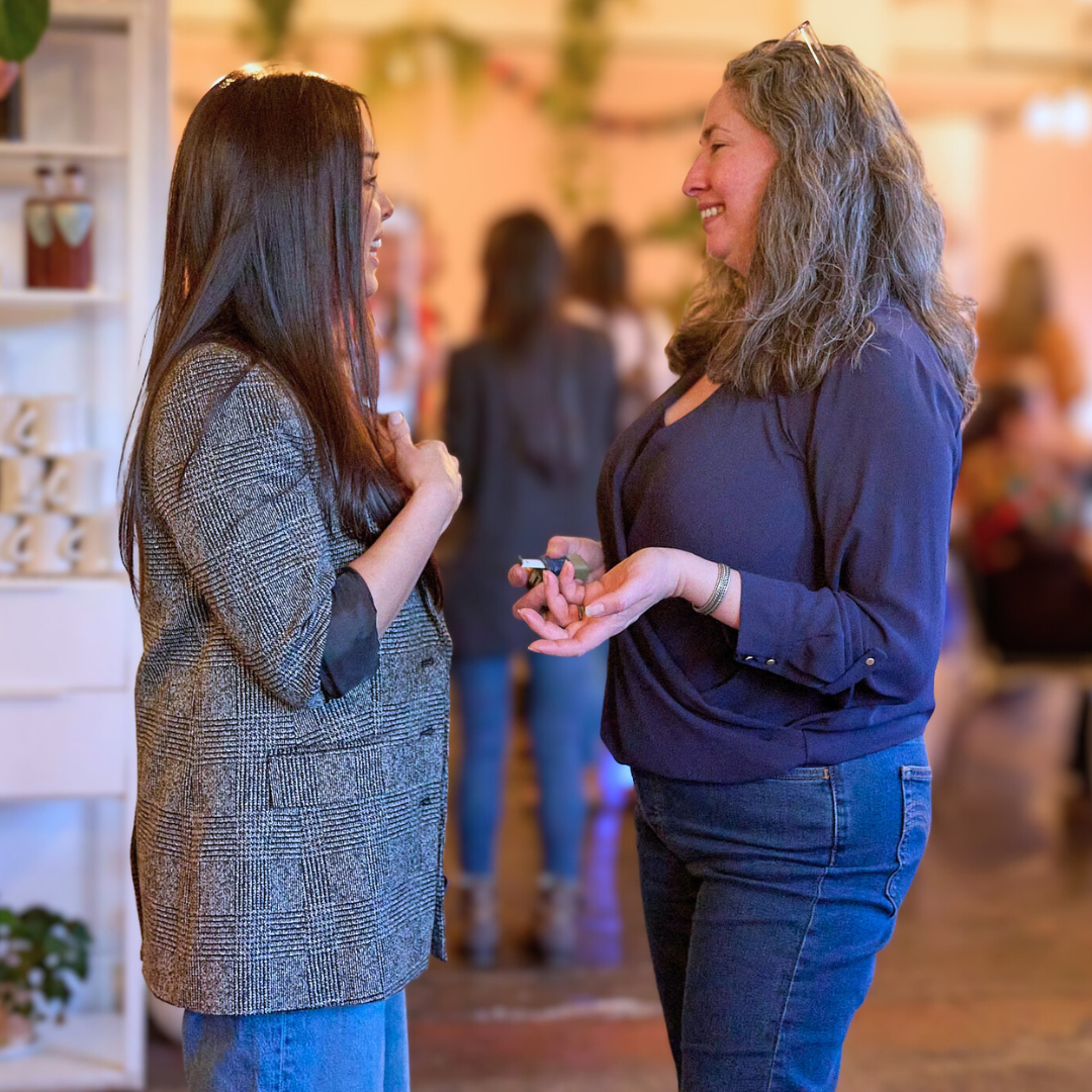 Seven women business owners from Xcelerate Women standing together for a posed photo at Bar Carlo
