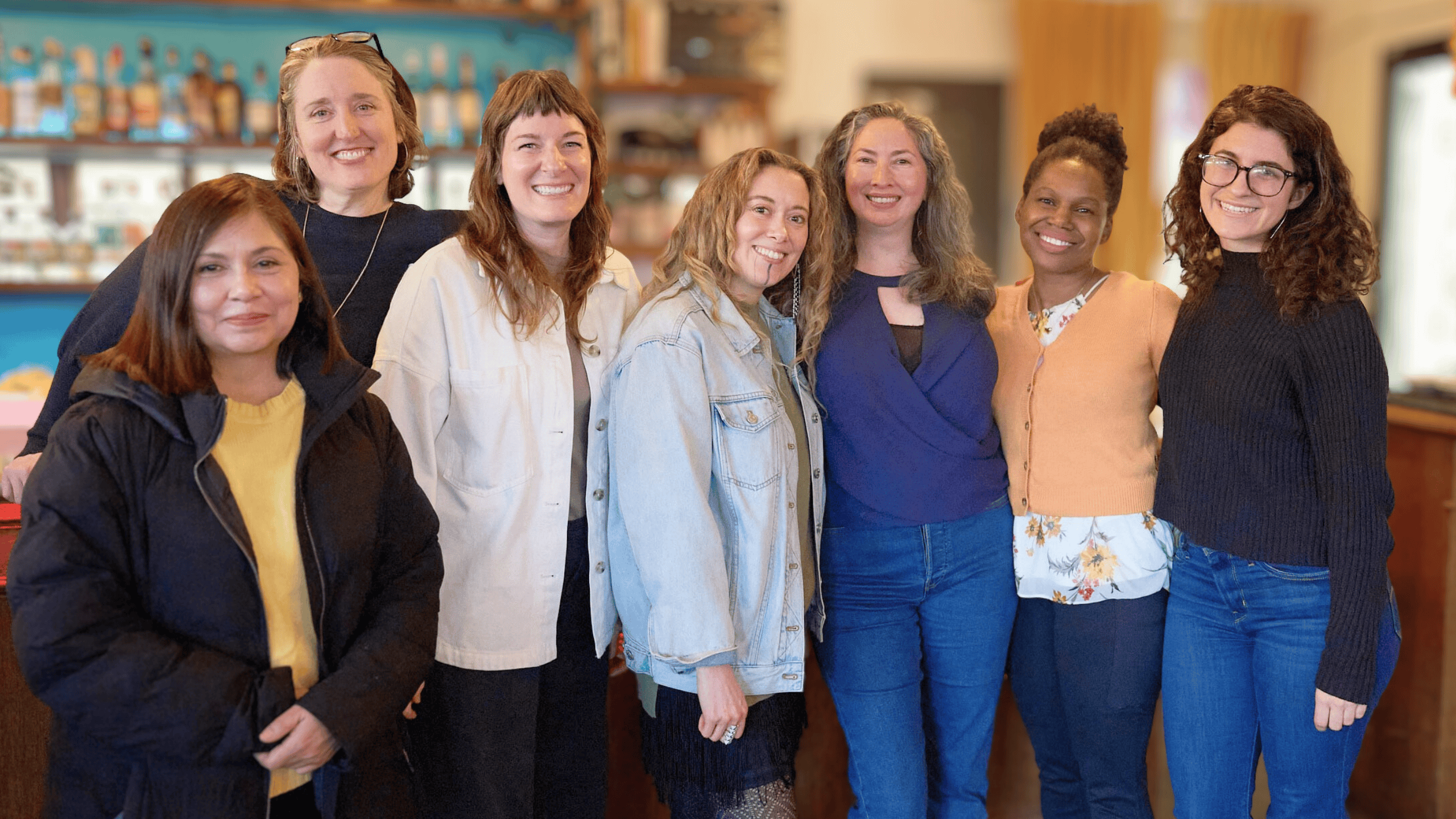 Seven women business owners from Xcelerate Women standing together for a posed photo at Bar Carlo