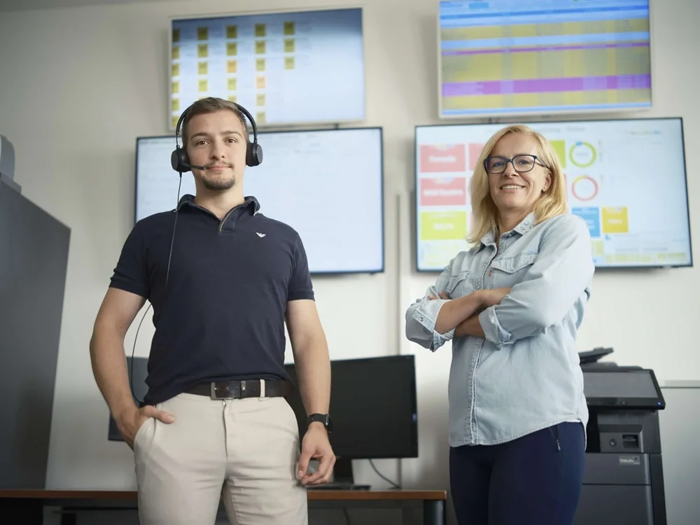 Truck driver inside the truck cabin, holding the steering wheel.