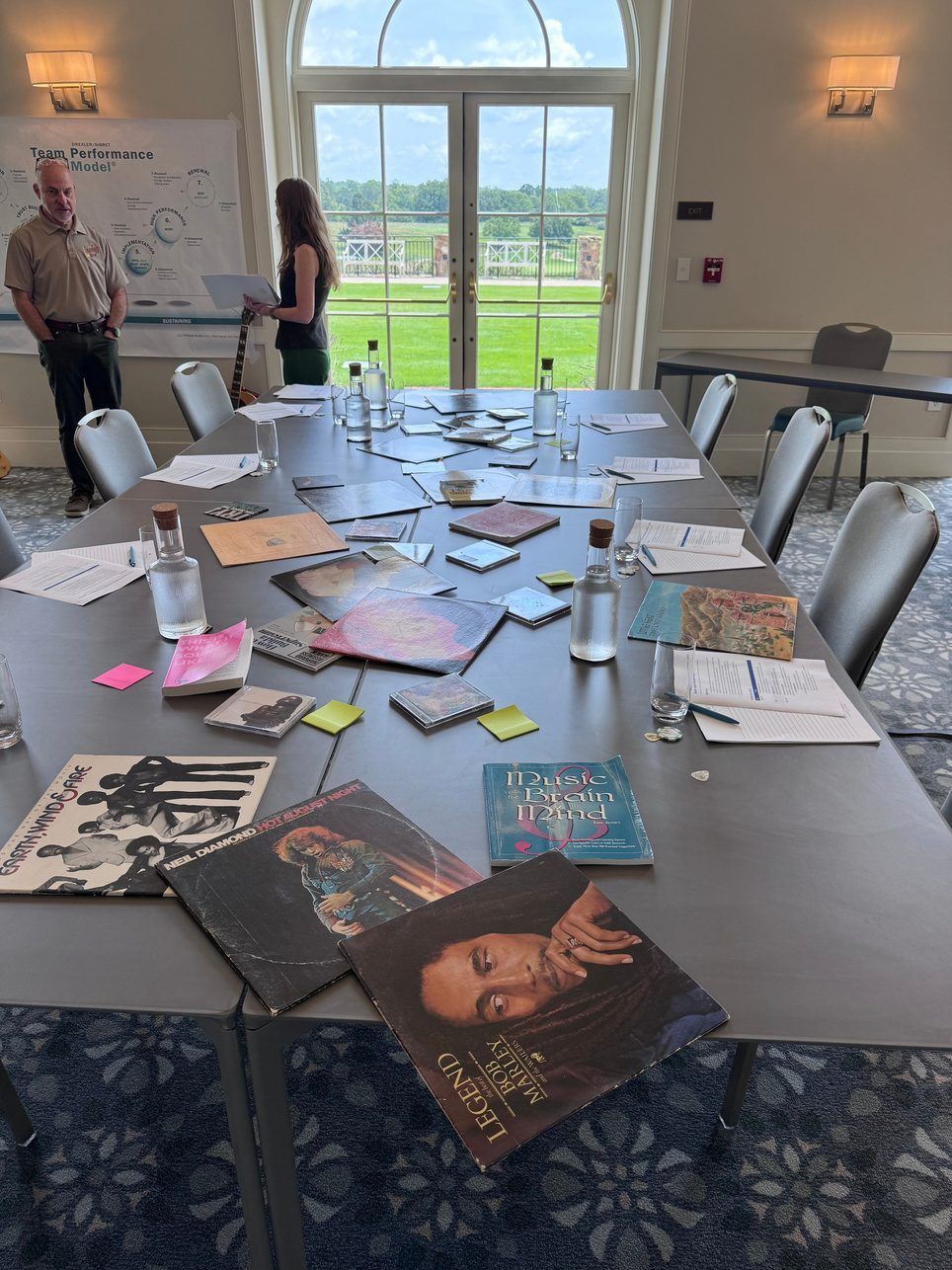 Record sleeves and notes on a meeting table
