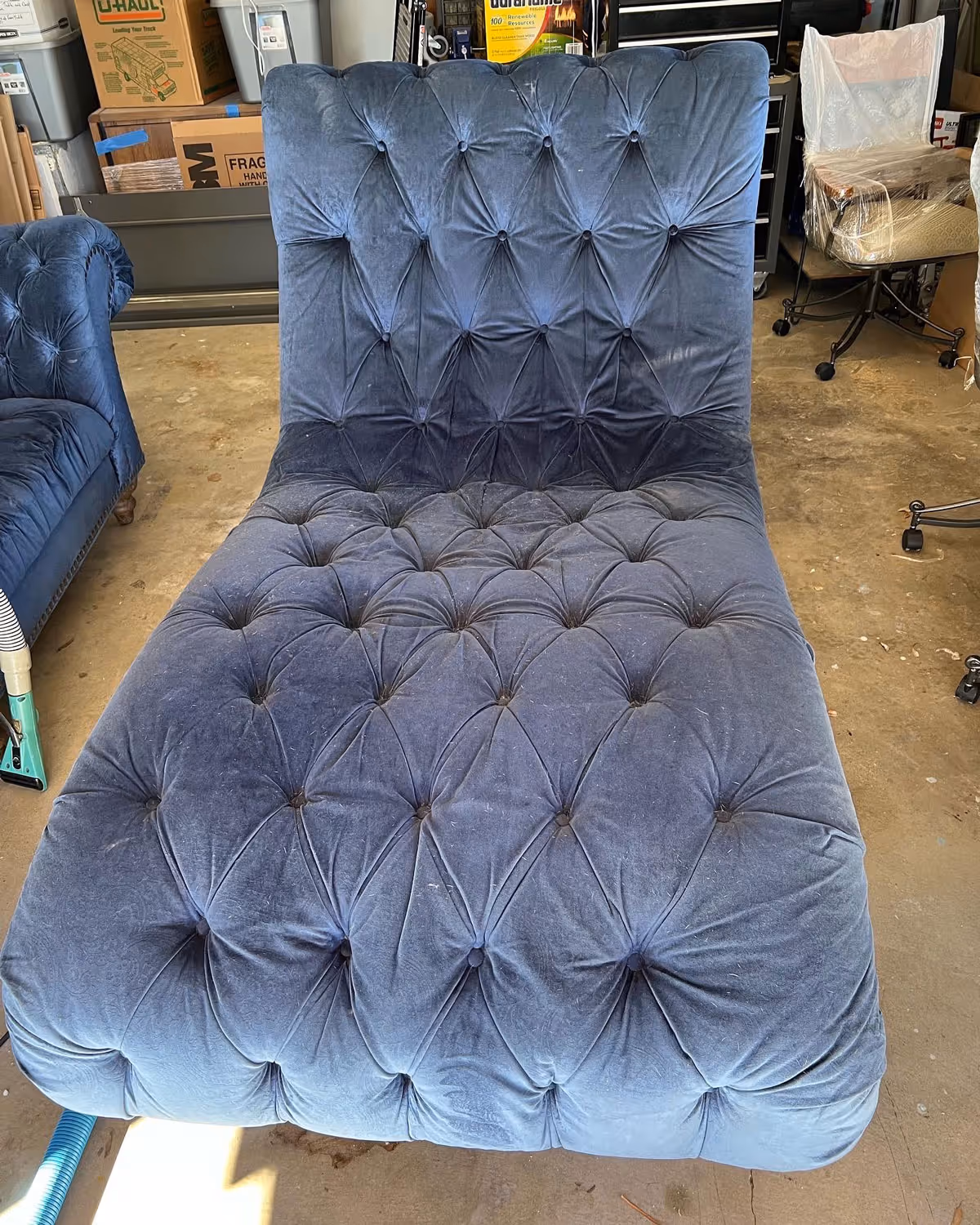 An upholstered blue chair before professional cleaning.